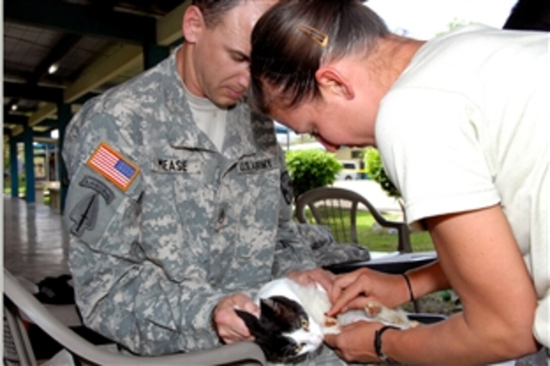 U.S. Army Staff Sgt. Danielle Kunz, right, an animal care specialist, along with Staff Sgt. Christopher Mease, a veterninary food inspector, treats a cat's wound during a medical readiness training exercise in Canita, Panama, Feb. 2, 2009. Kunz and Mease are assigned to the 949th Medical Detachment, U.S. Army Reserve Veterinary Corps.