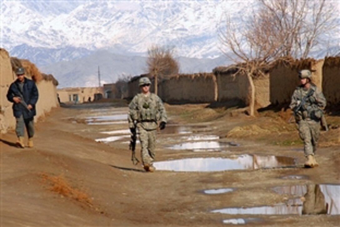 U.S. Army soldiers and an Afghan National Police officer conduct a cache patrol through a village in Bagram, Afghanistan, Feb. 5, 2009. The soldiers are assigned to 101st Airborne Division's Company A, 1st Platoon Personnel Security Detail.