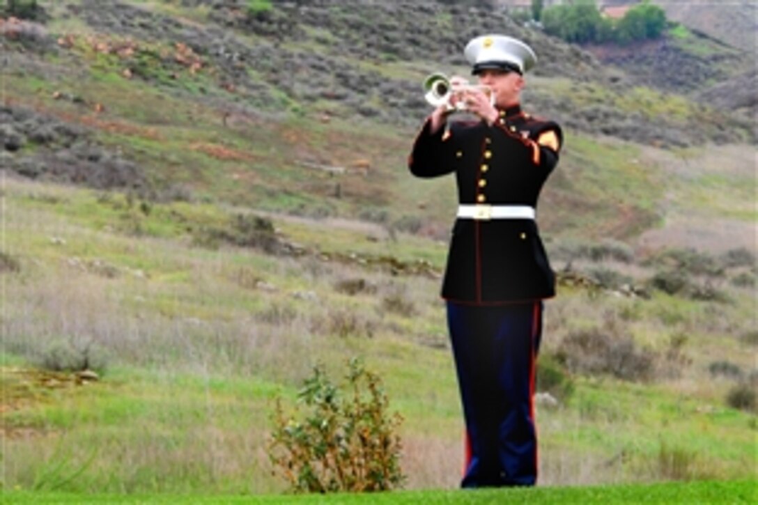 A bugler from the 3rd U.S. Marine Aircraft Wing Band plays Taps at the Ronald Reagan Memorial site after a ceremony honoring the anniversary of Reagan's birth at the Ronald Reagan Presidential Library and Museum in Simi Valley, Calif., Feb. 6, 2009.