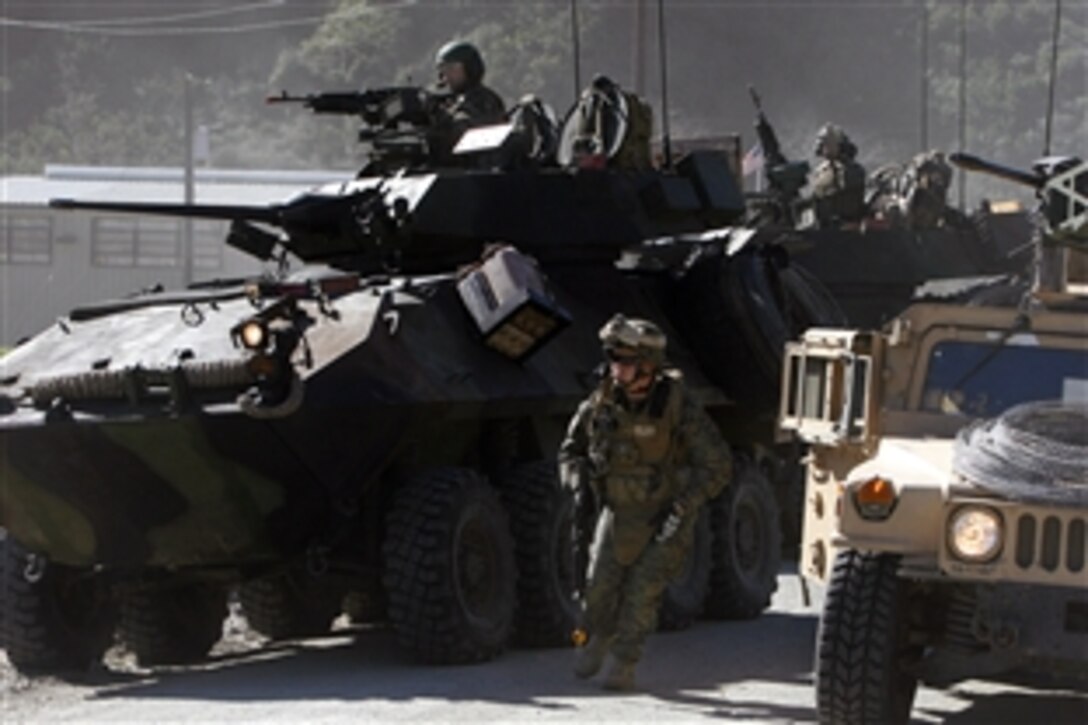 U.S. Marines begin a raid on combat town after their convoy is attacked with a simulated improvised explosive device here on Marine Coprs Base Camp Pendleton, Calif., Feb. 3, 2009. The Marines are assigned to Weapons Company, 2nd Battalion, 4th Marine Regiment. The training is conducted as part of a six day raid training package to prepare the Marines for their upcomming deployment later this year. 