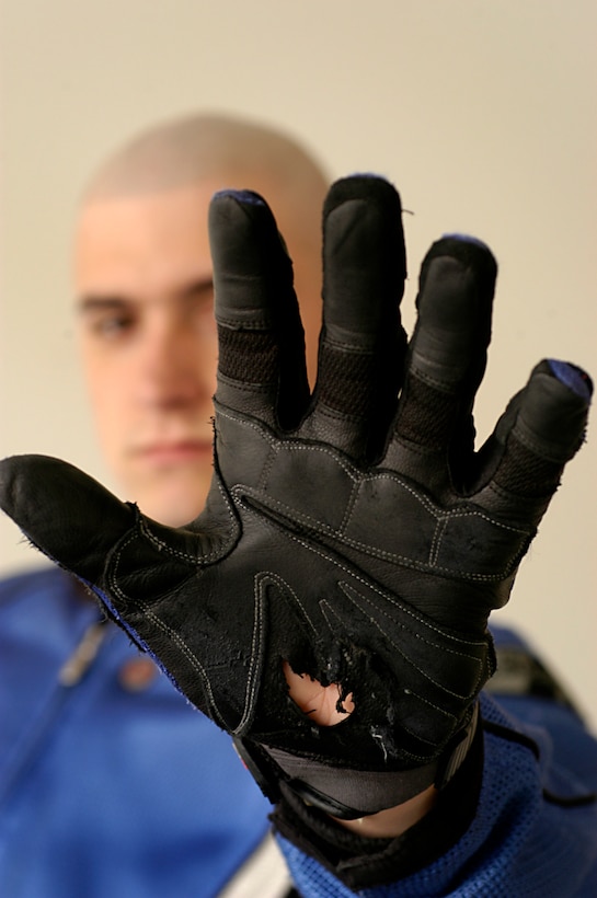 Lance Cpl. Charles M. Gardner shows the hole in his glove he received after a motorcycle accident Feb. 3, 2009, near the Marine Corps Air Station in Yuma, Ariz. While the glove was shredded, his palm was not affected. Gardner, an air traffic control equipment maintainer at the air station, suffered only minor injuries when he laid down his Yamaha FZ6 sport bike to avoid a collision with a car that veered into his lane. Gardner, 21, is a native of Houston. (Photo by Gunnery Sgt. Bill Lisbon)