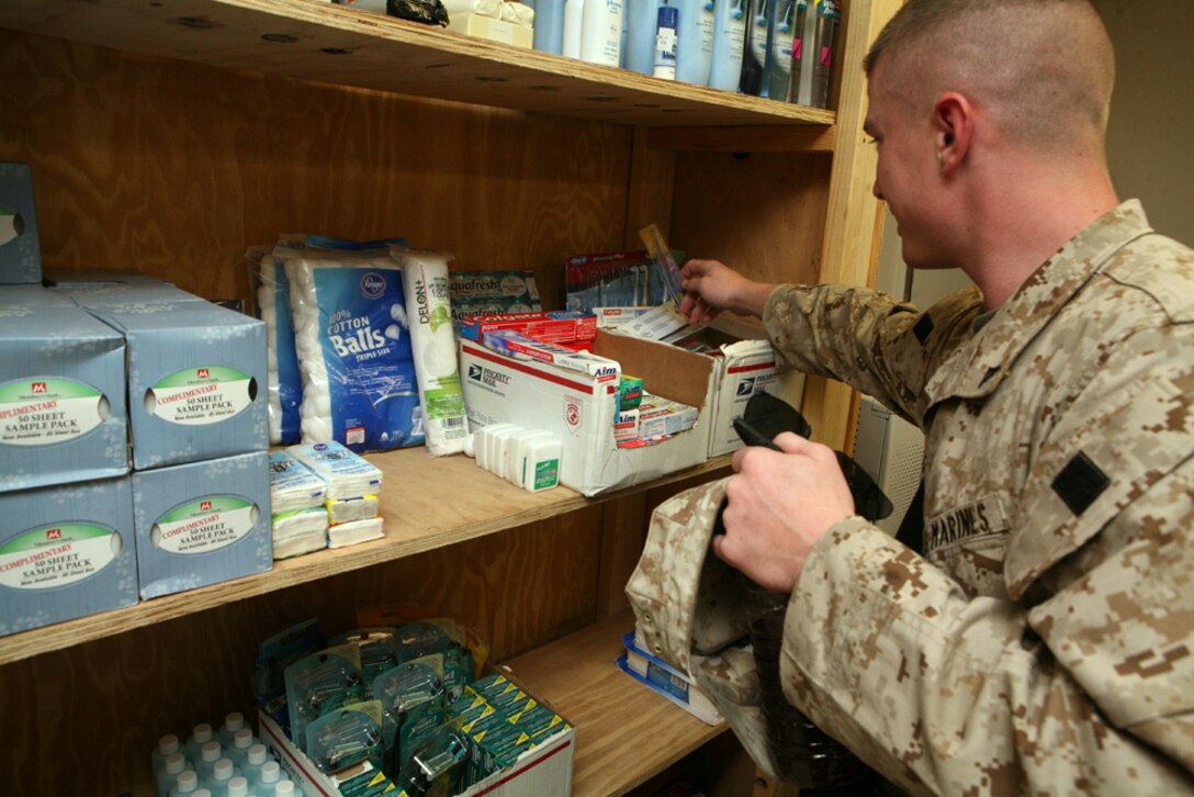 Lance Cpl. Marcus McMurray, a command-operations-center journal clerk with Headquarters Company, Regimental Combat Team 8, sifts through donated hygiene items at the chapel annex here. Marines and sailors enjoy the ability to leisurely stroll through the well organized store, sifting through free hygiene items and other donated goods.
