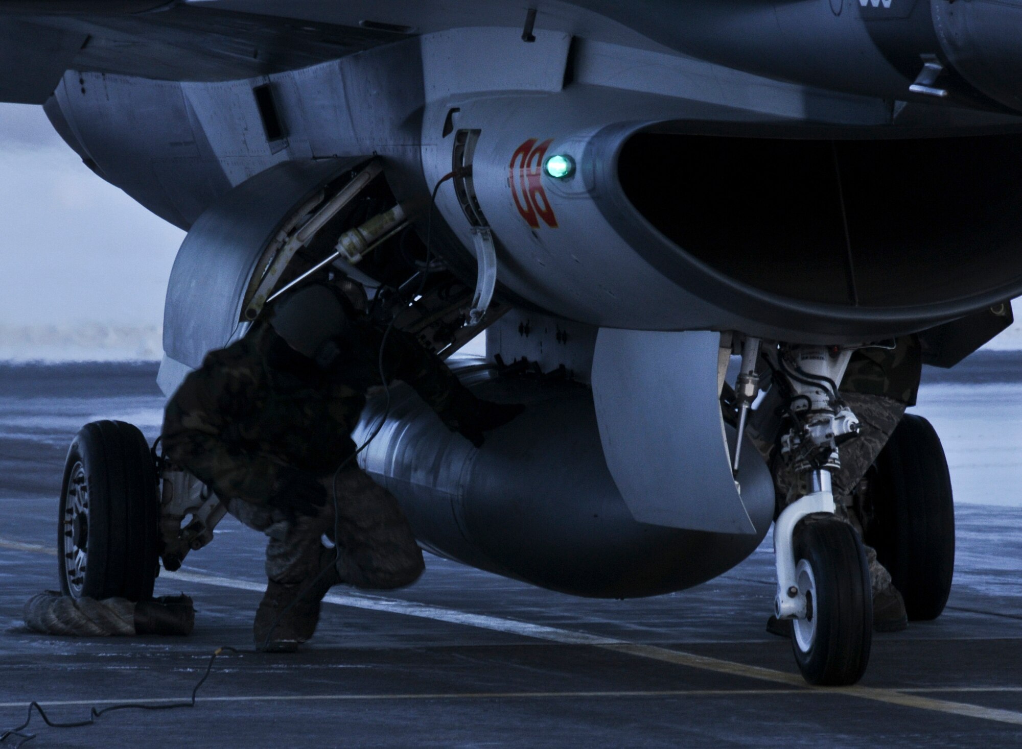 Airman Adam Marks removes a pin on an F-16 Fighting Falcon Feb. 5, 2009 at Eielson Air Force Base, Alaska.  The crew performs final checks at the end of the runway to ensure safety and keep the aircraft mission ready. Airman Marks is with the 354th Aircraft Maintenance Squadron where he is an armament systems apprentice.(U.S. Air Force photo/Airman 1st Class Laura Max)