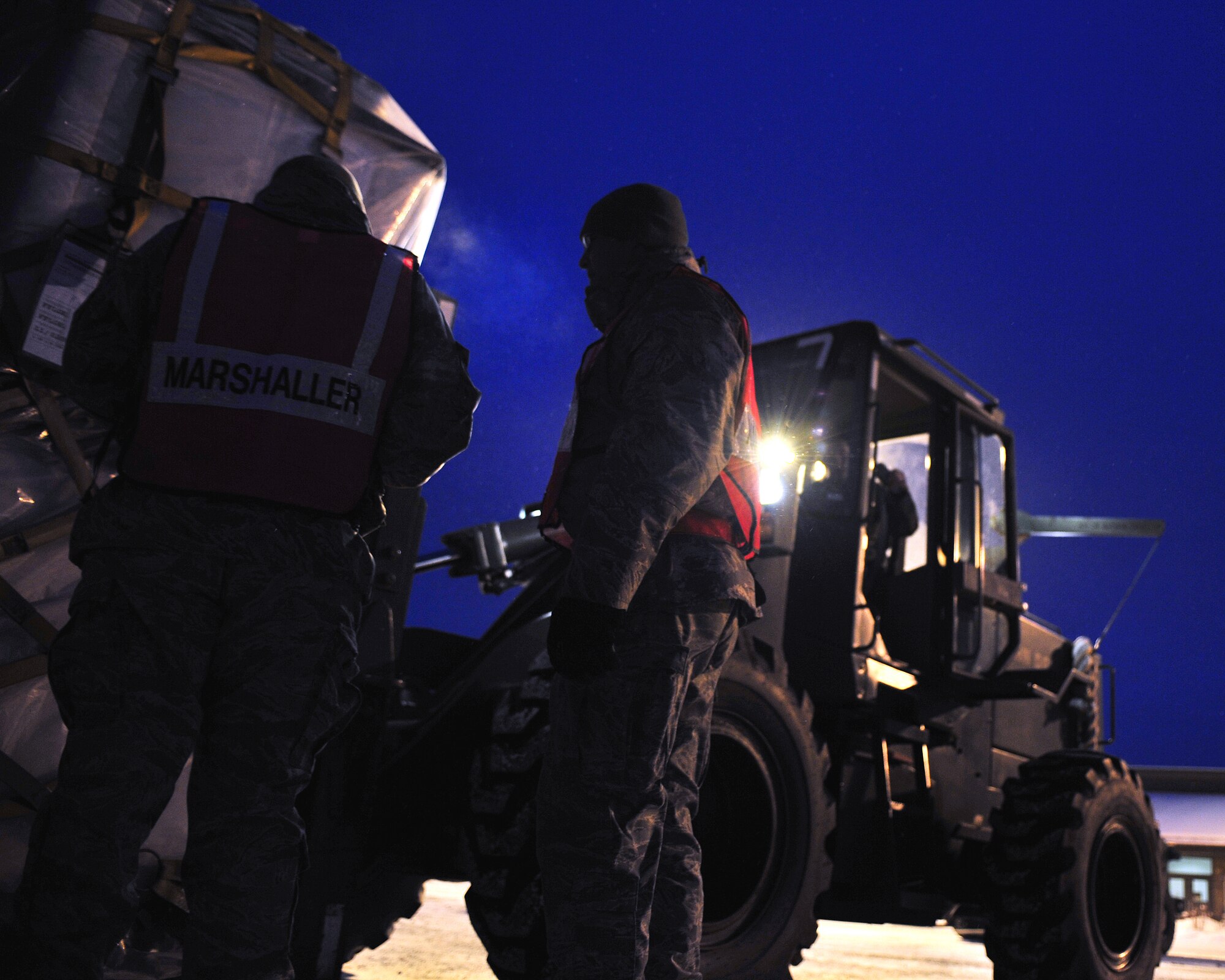 Airmen from the 354th Logistics Readiness Squadron ensure a pallet is properly secured Feb. 9, 2009 during an operational readiness exercise. It is vital that cargo is properly secured to prevent incidents from occuring during the loading, transport and unloading processes. (U.S Air Force photo/Airman 1st Class Willard E. Grande II)