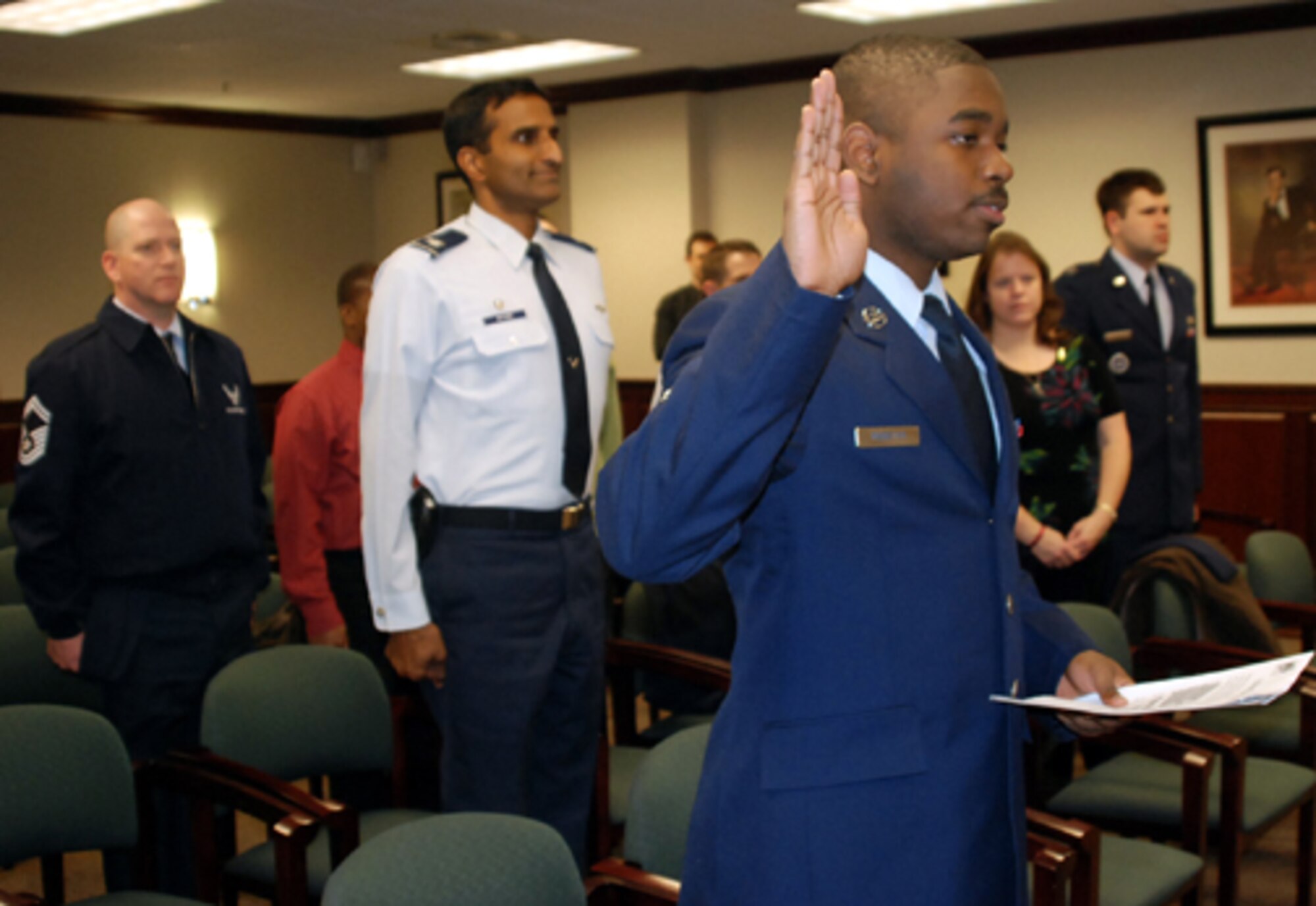 Senior Airman Darren Webster, 305th Maintenance Operations Squadron, swears in as a U.S. citizen Feb. 9 in Mount Laurel, N.J. Leadership from the 305th Air Mobility Wing, along with co-workers and friends, joined Airman Webster during his Oath of Citizenship. (U.S. Air Force photo/Senior Airman Bekah Phy) 