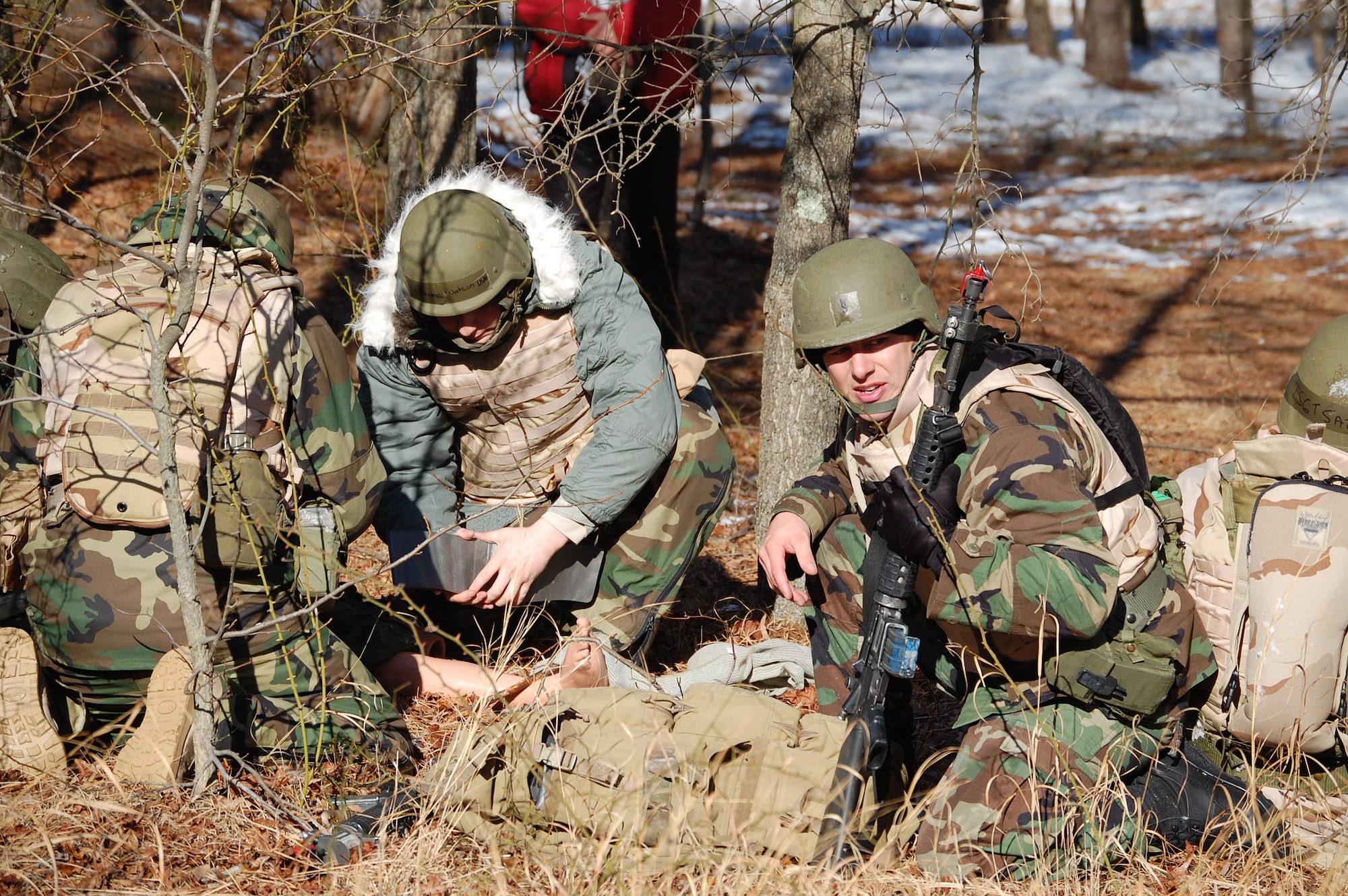 Students in the Advanced Contingency Skills Training Course respond to a scenario during a training session in combat first aid on Feb. 5, 2009, on a Fort Dix, N.J., range.  ACST is taught by the U.S. Air Force Expeditionary Center's 421st Combat Training Squadron and prepares Airmen for upcoming deployments.  (U.S. Air Force Photo/Tech. Sgt. Scott T. Sturkol)