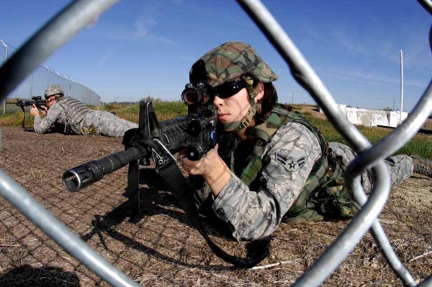 MINOT AIR FORCE BASE, N.D. – Senior Airman Ashley Woods, at the time an airman first class with the 791st Missile Security Forces, provides simulated cover fire while other members from the response force sweep the Minuteman III intercontinental ballistic missile launch facility during a LF recapture exercise, here Sept. 29. Airman Woods is currently an alternate resource advisor with  the 91st Security Forces Group, and until recently, a dance member for the Minot SkyRockets. (U.S. Air Force photo by Senior Airman Joe Rivera)