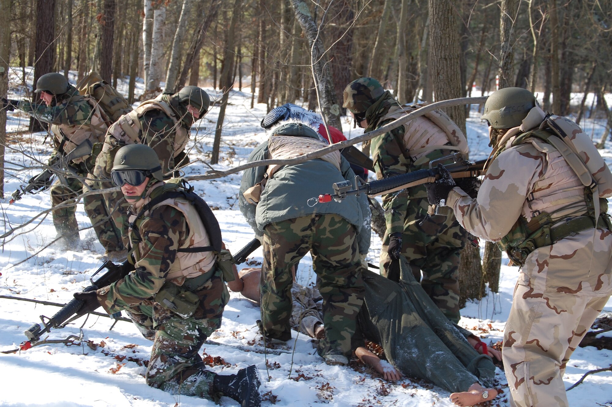 Students in the Advanced Contingency Skills Training Course respond to a scenario during a training session in combat first aid on Feb. 5, 2009, on a Fort Dix, N.J., range.  ACST is taught by the U.S. Air Force Expeditionary Center's 421st Combat Training Squadron and prepares Airmen for upcoming deployments.  (U.S. Air Force Photo/Tech. Sgt. Scott T. Sturkol)