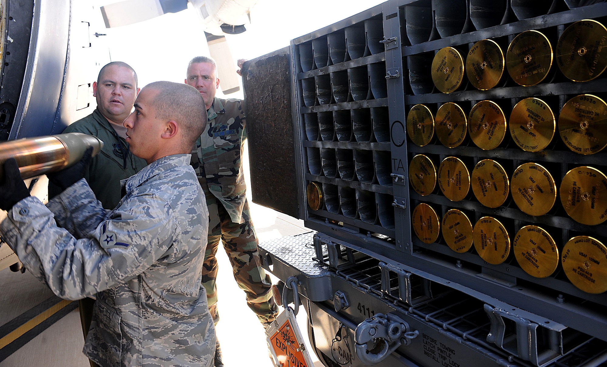 Cannon Air Force Base, N.M. -- Amn. Frank Lauria, of the 27th Special Operations Equipment Maintenance Squadron Munitions Flight, hands a 105 mm cannon round to an aerial gunner inside a 16th Special Operations Squadron AC-130H Spectre gunship while training on the Combat Aircraft Parking Area here Feb. 6. Airman Lauria and the munitions flight will be responsible for supplying live and training ammunition to special operations aircraft moving to the base. The Air Force Special Operations Training Center observed the loading procedures to help create a formal training program for use throughout Air Force Special Operations Command. (U.S. Air Force photo/Airman 1st Class Evelyn Chavez) 