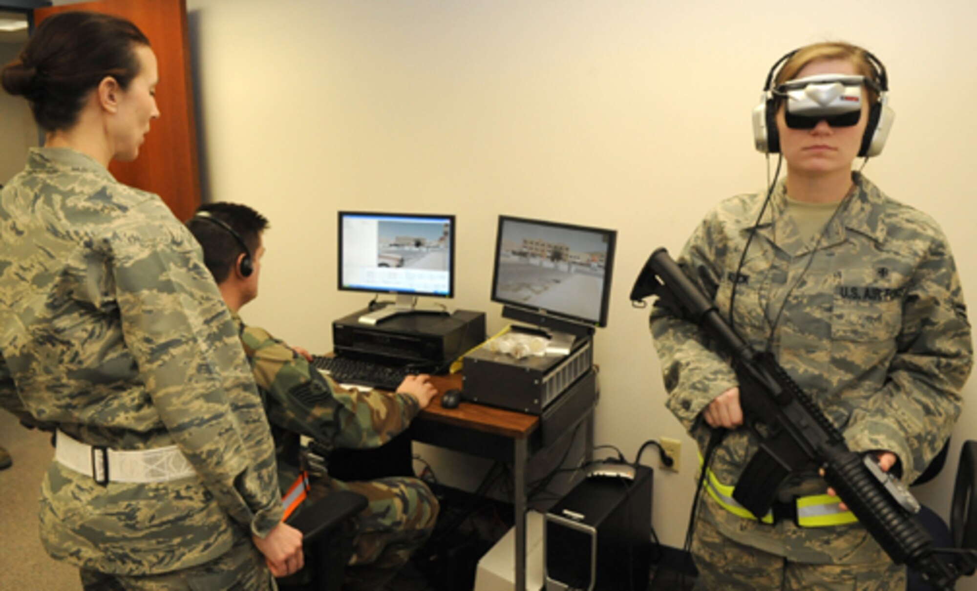 Major Terri Davis, 305th Medical Group Mental Health Flight commander, and Tech. Sgt. Theodore Kraszka, mental health NCOIC and Bronze Star recipient, take Airman 1st Class Nichole Kuck, mental health tech, on a training run through “Virtual IRAQ”. Virtual IRAQ is the latest in technology used to assist Airmen and troops with post traumatic stress disorders. Using the senses of sight (virtual glasses), hearing (headset), feeling (vibrating platform), and even smell (distinct scents) to help patients during prolonged exposure therapy. (U.S. Air Force photo/Wayne Russell)
