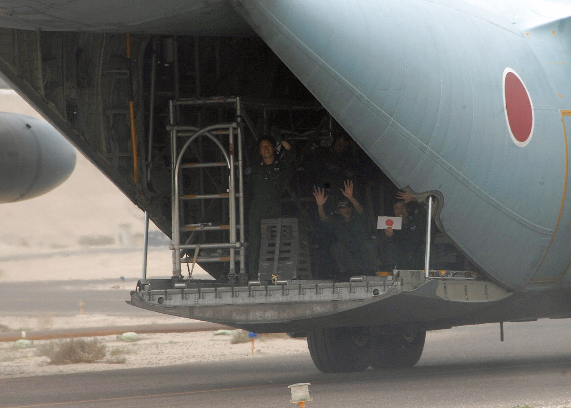 Members of the Japanese Air Self Defense Force redeployment group wave goodbye from the back of their C-130 Hercules at an air base in Southwest Asia Feb. 10. The JASDF are returning to Japan after working alongside coalition forces since 2004. (U.S. Air Force photo/Senior Airman Courtney Richardson) 