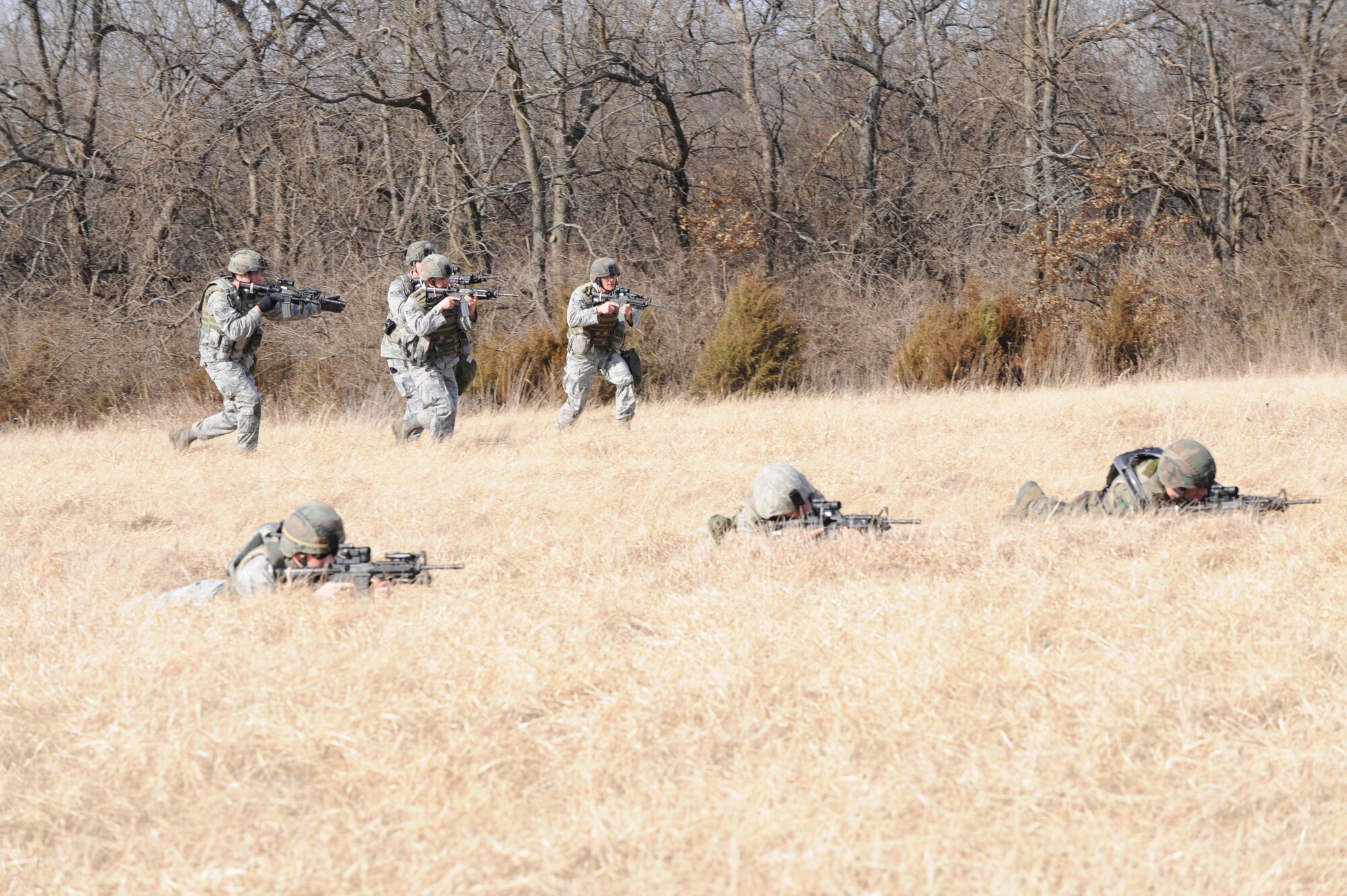 WHITEMAN AIR FORCE BASE, Mo. – Airmen from the 509th Security Forces Squadron charge forward with weapons ready at the Cobra training site during the Blue Coach training course  Feb. 6. (U.S. Air Force photo/Staff Sgt Charles Larkin)