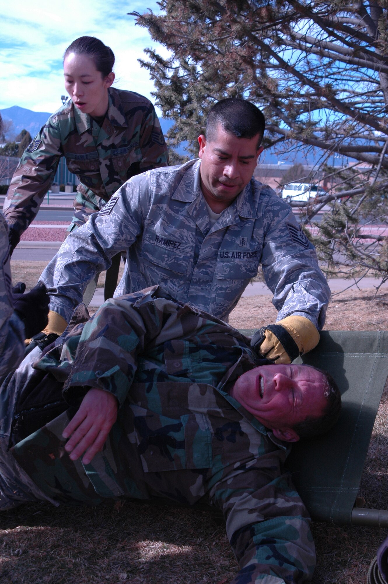 Staff Sgt. Sonja Earle, 302nd Aeromedical Staging Squadron lab technician and Tech. Sgt. Luis Ramirez, a medical technician in the same squadron, prepare to move a mock patient out of harm's way Feb. 7, 2009, at Peterson Air Force Base, Colo. Members of their military unit and the 34th Aeromedical Evacuation Squadron, conducted an annual, mass-casualty training exercise at the base to ensure quality and timely patient care is always provided when needed. More than 40 medical personnel tended to approximately 25 mock patients who were "suffering" from various traumas. "It's important to coordinate our skills and resources to provide patient care." said Staff Sgt. Ibrahim Farah, 34th Aeromedical Evacuation Squadron. "We've got to bond extremely quickly. We're all medical personnel here; we know what has to be done; and we need to get it done." (U.S. Air Force photo/Tech. Sgt. Daniel Butterfield)