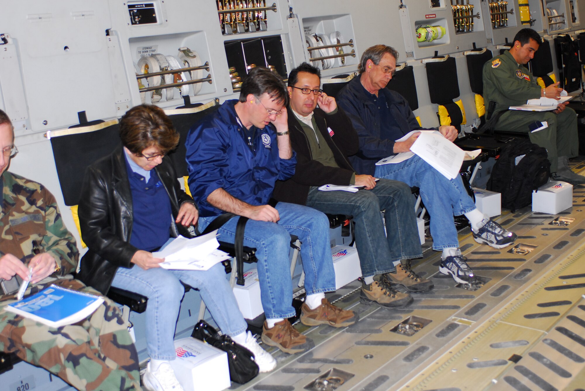 From left, Evelyn Delgado, Department of State Health Services assistant commissioner for Family Community Health Services; Dr. David Lakey, DSHS commissioner; Dr. Adolfo Miguel Valadez, DSHS assistant commissioner for Prevention and Preparedness Services; and Rick Bays, DSHS Response and Recovery Unit director, sit ready for takeoff of a C-17 aircraft from Lackland Air Force Base, Texas, Feb. 7. The DSHS took the flight to learn about the aircraft and its medical evacuation capabilities. (TXMF photo by Tech. Sgt. Rene Castillo)