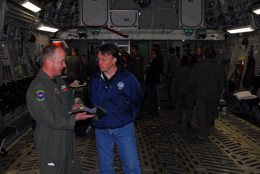 Chief Master Sgt. Rodney Christa, 433rd Aerospace Evacuation Squadron superintendent, explains C-17 aircraft operations to Dr. David Lakey, commissioner of the Department of State Health Services (DSHS), prior to takeoff. Dr. Lakey boarded the C-17 at Lackland Air Force Base, Texas, Feb. 7 to learn about the C-17 and its medical evacuation capabilities. (TXMF photo by Tech. Sgt. Rene Castillo)