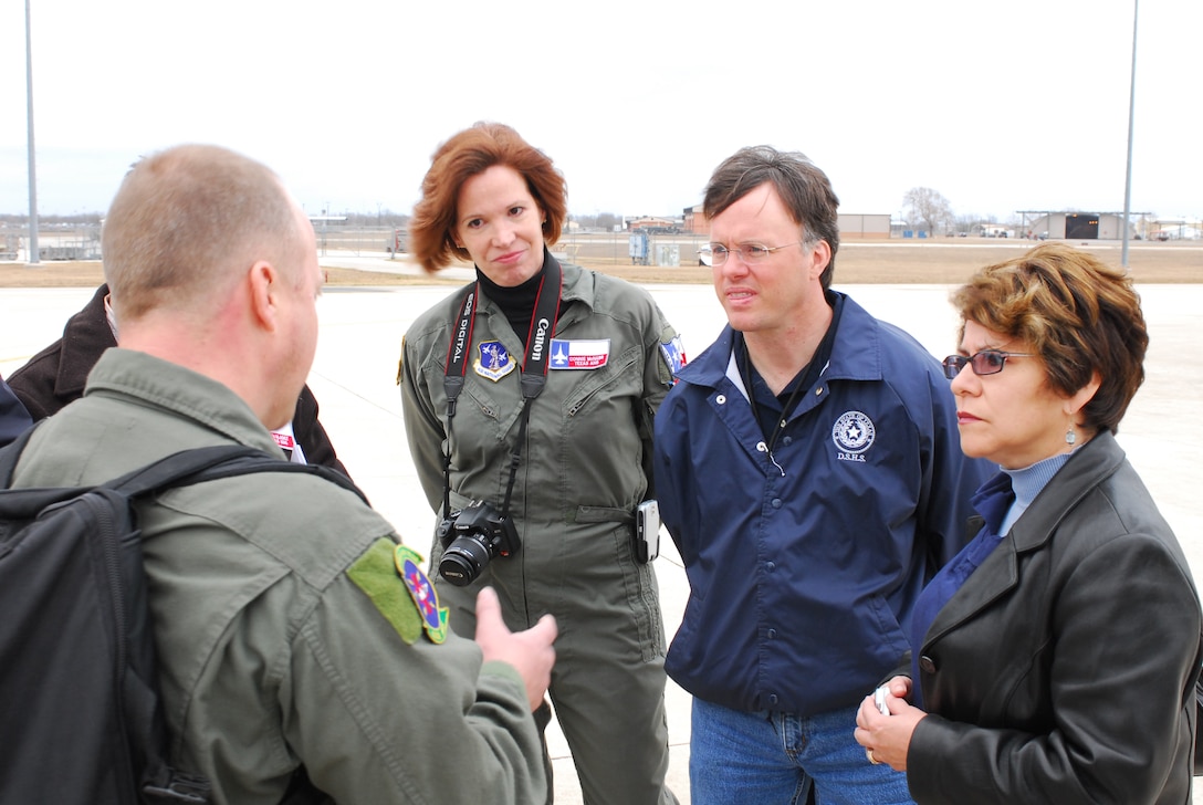 Col. (Dr.) Connie McNabb, Texas Military Forces State Joint Surgeon; Dr. David Lakey, commissioner of the Department of State Health Services (DSHS); and Evelyn Delgado, DSHS assistant commissioner for Family Community Health Services, listen to Chief Master Sgt. Rodney Christa, 433rd Aerospace Evacuation Squadron superintendent, brief them prior to boarding a C-17 aircraft. Colonel McNabb and the DSHS guests visited Lackland Air Force Base Feb. 7 to learn about the C-17 and its medical evacuation capabilities. (TXMF photo by Tech. Sgt. Rene Castillo)