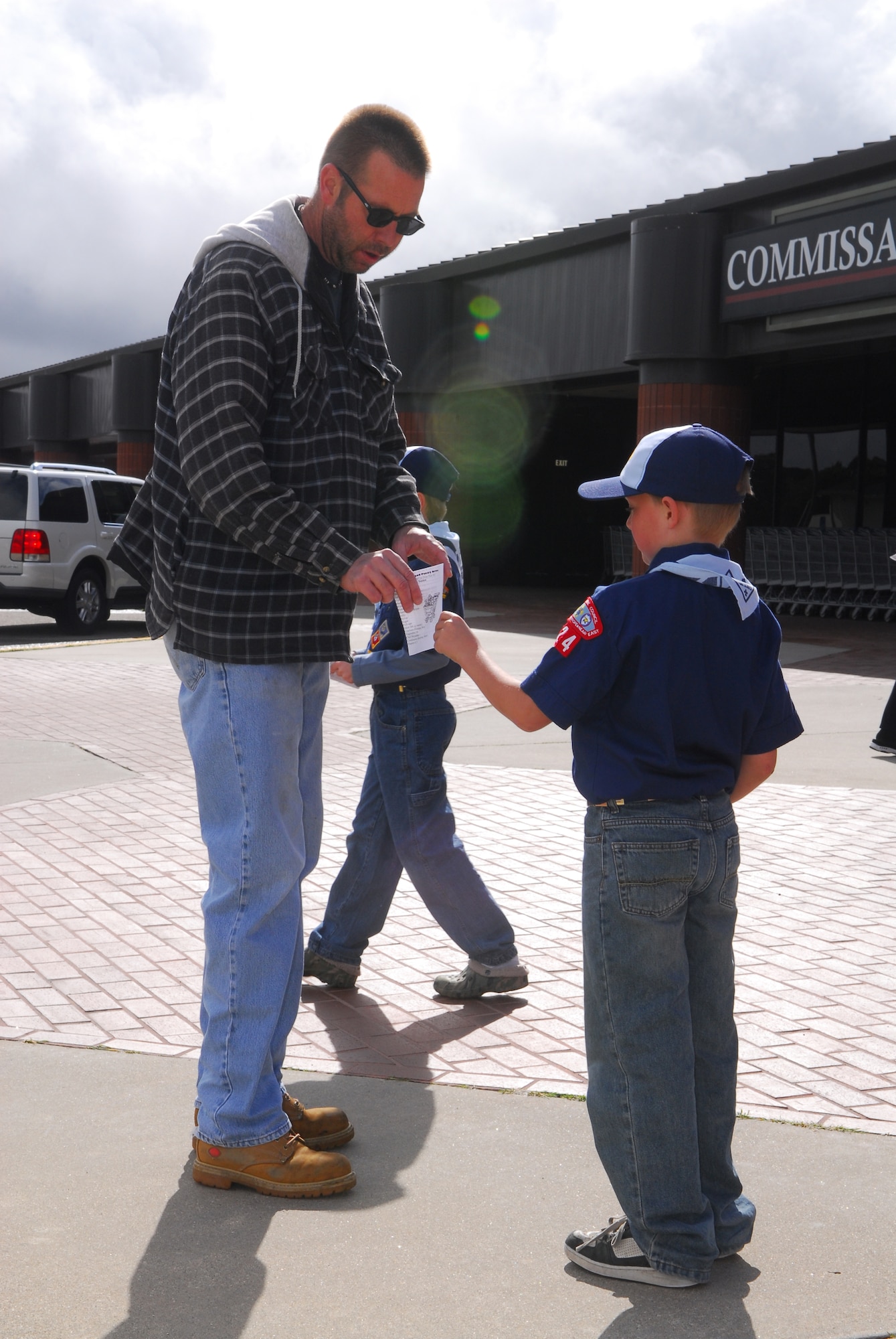 Members of Cub Scout Pack 102 participate in a local food drive Feb. 7 by passing out flyers to shoppers at the base commissary.  The food collected was
sent to the food pantry at Vandenberg's Airman & Family Readiness Center
where it will be given out to families that qualify for the program.  (U.S.
Air Force photo/Airman 1st Class Steve Bauer)
