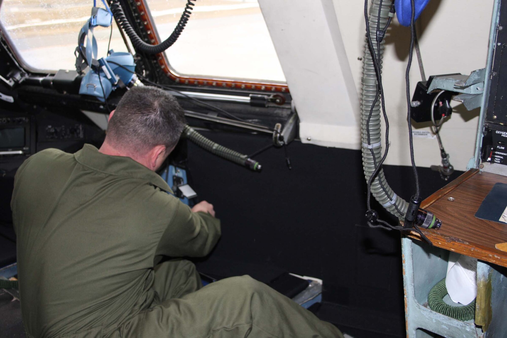 WRIGHT-PATTERSON AFB, Ohio – Tech. Sgt. Mark McQueen, 653rd Combat Logistics Support Squadron, Robins Air Force Base, Ga., installs a piece of armor on the flight deck of a C-5 Galaxy belonging to the 445th Airlift Wing.  Several pieces are put together like a big jigsaw puzzle to form the armor and connected with Velcro.  The armor will protect the flight crew from small arms fire from the ground and will reduce the threat of damage to vital, internal parts of the aircraft. (Air Force photo/Stacy Vaughn)