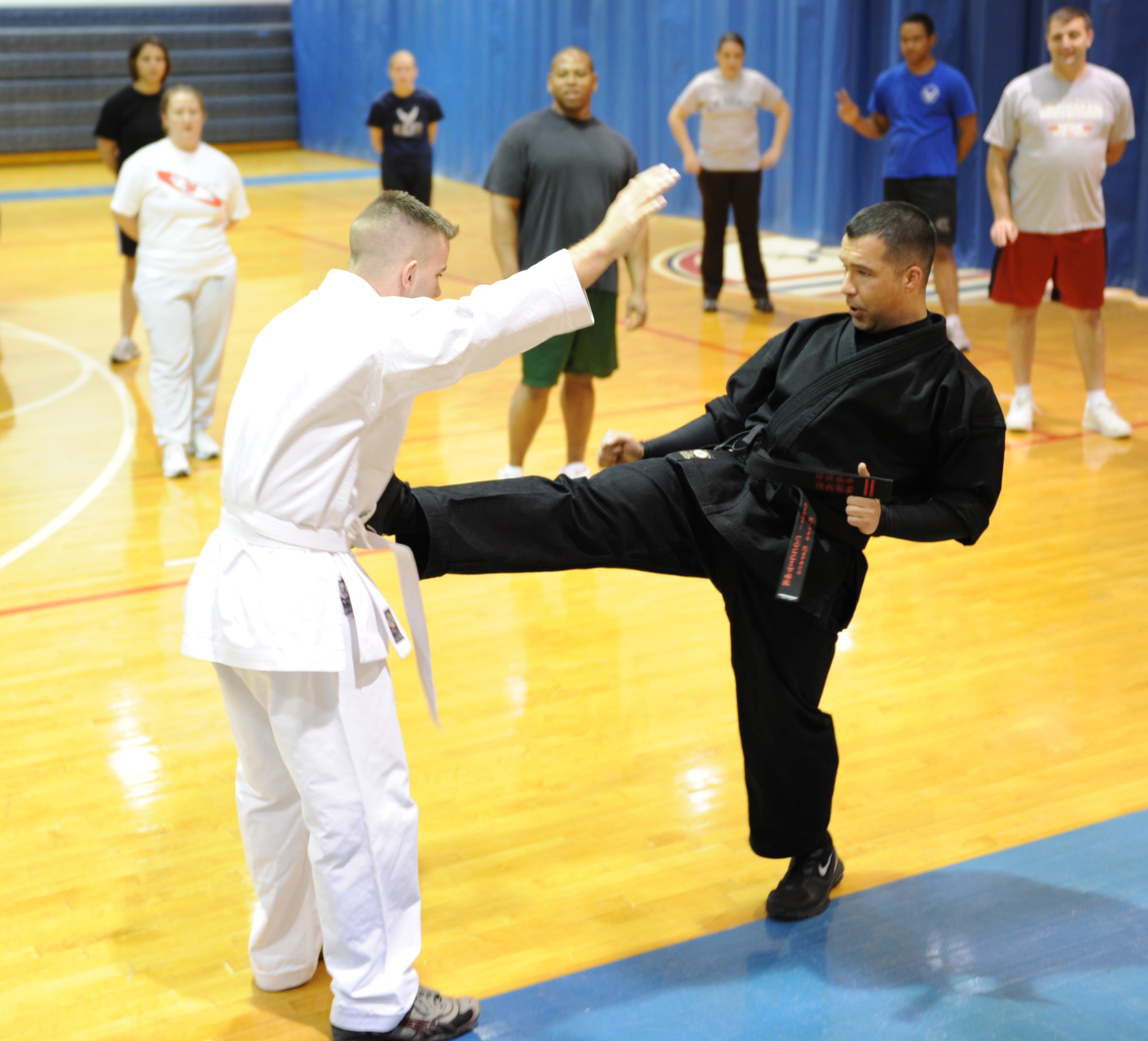 WHITEMAN AIR FORCE BASE, MO. – Sensei Larry Tolliver, Kenpo Instructor, kicks Senior Airman Cory Todd, a Kenpo student and member of the 509th Bomb Wing Public Affairs, during a demonstration for his class Feb. 2. Kenpo is a Japanese term that translates to mean “Law of the Fist.” Classes are Mondays and Wednesdays from 5 – 6 p.m. at the fitness center for $8 a class. (U.S. Air Force photo/Senior Airman Stephen Linch)