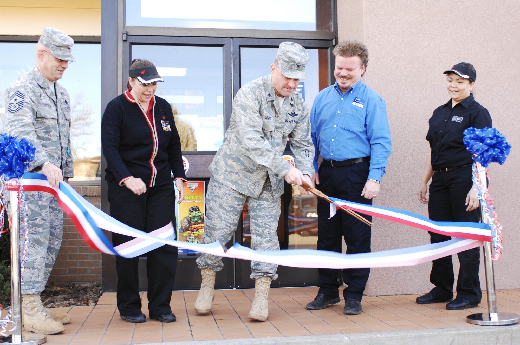 CANNON AIR FORCE BASE, N.M. - Col. Timothy Leahy, 27th Special Operations Wing commander, along with Chief Master Sgt. Daniel Fischer, 27 SOW command chief, and AAFES and Burger King employees cuts the ribbon during the Burger King reopening Feb. 6. Burger King has been closed for the past month for renovations to the restaurant. (U.S. Air Force photo/Airman 1st Class Elliott Sprehe)