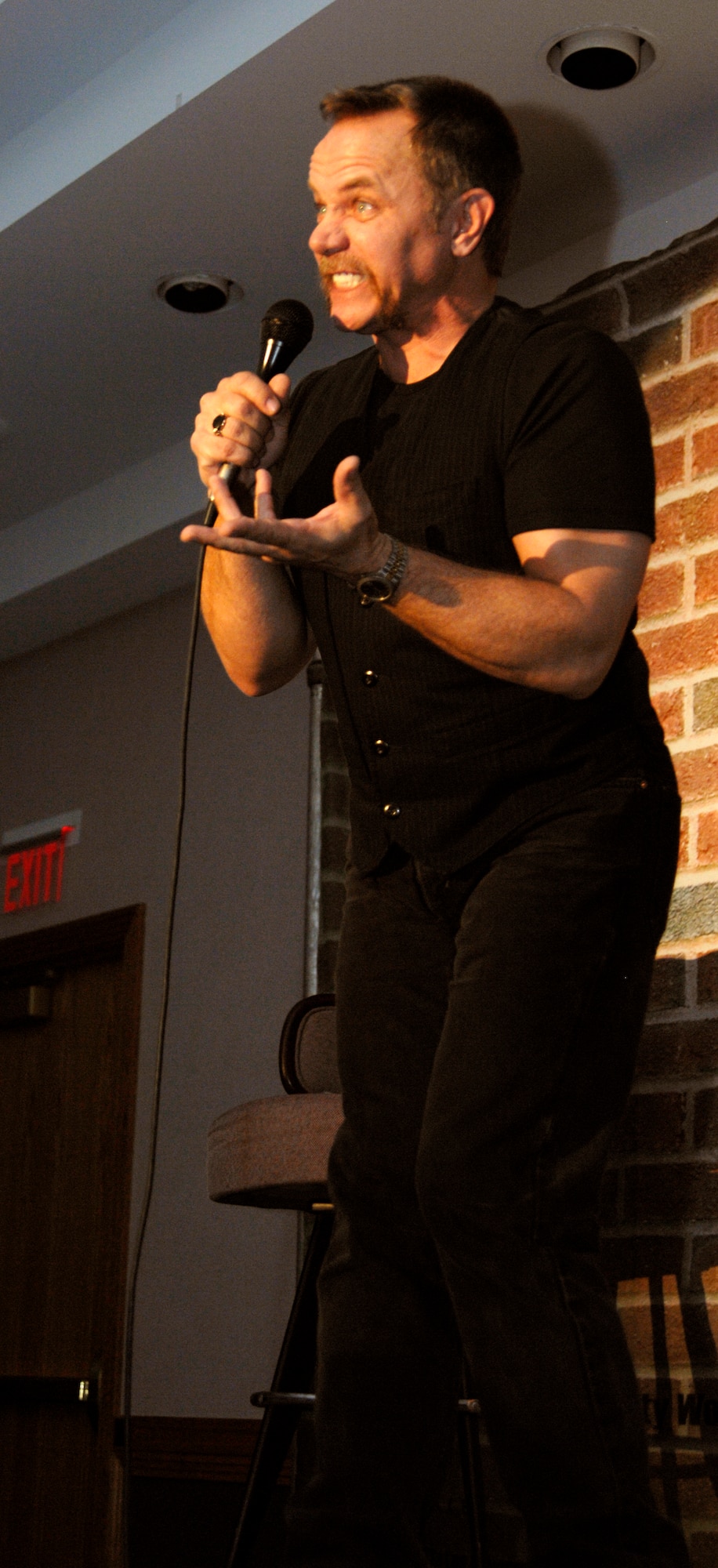 WHITEMAN AIR FORCE BASE, Mo. - Comedian Tom Foss delivers the punch line to a joke during the Comics on Duty World Tour at the Mission’s End Feb. 6. More than 200 members of Team Whiteman attended the event and were treated to a night full of laughs. Mr. Foss has traveled the world nine times as part of the Comics on Duty and has been a comedian for more than 20 years. (U.S. Air Force photo/Staff Sgt. Jason Barebo)