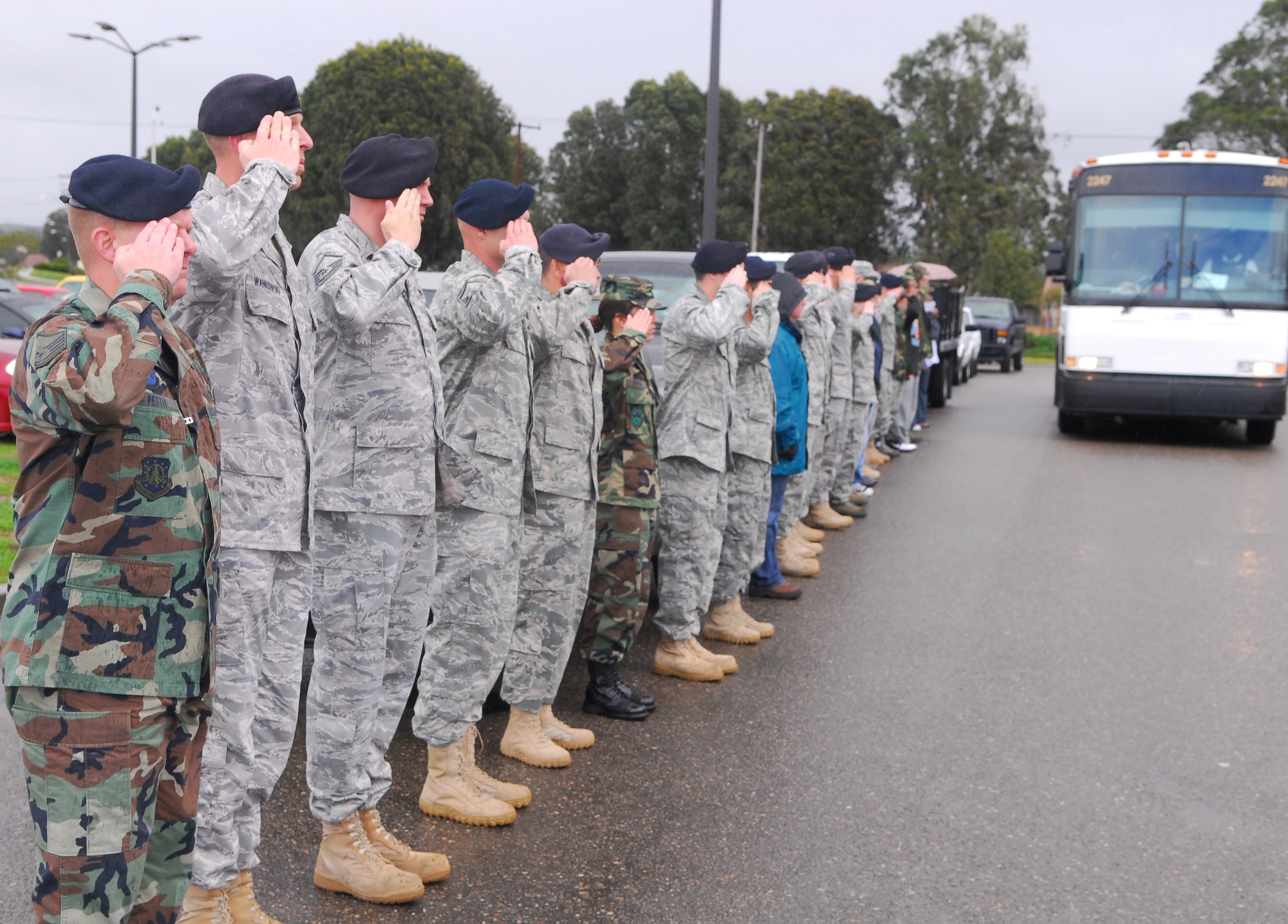 VANDENBERG AIR FORCE BASE, Calif. -- Members from the 30th Security Forces Squadron lined up to salute their departing fellow servicemember leaving for a deployment Feb. 6. The 30th SFS sent a 13 member team on a six-month deployment to a forward operating base in Iraq. (U.S. Air Force photo/Airman 1st Class Steve Bauer)