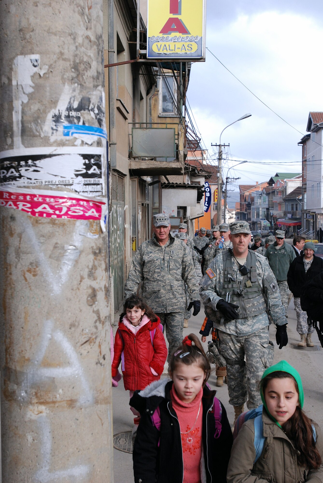 Gen. Craig R. McKinley, right, chief of the National Guard Bureau, and Army Capt. Shannon Dean Holiday, commander of Multinational Task Force East's Thunder Bravo battery, walk the streets of downtown Pristina, Kosovo, during a presence patrol with the Missouri Army National Guard. (U.S. Air Force photo/Master Sgt. Mike R. Smith)
