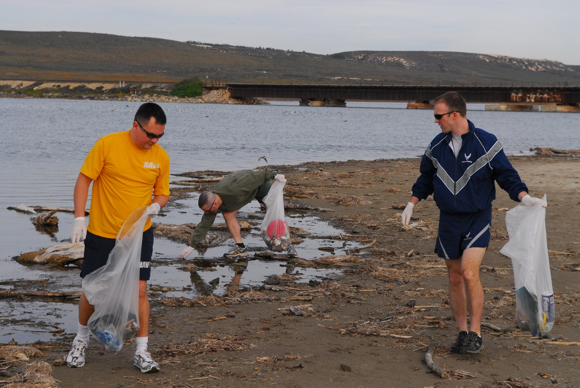 VANDENBERG AIR FORCE BASE, Calif. – Maj. Joe Iungerman, Navy Cmdr. Stephen Higuera and Marine Maj. Brian Anderson, from the Joint Functional Component Command for Space,cleanup trash Feb. 5 along Surf Beach. (U.S. Air Force photo/Airman 1st Class Steve Bauer)