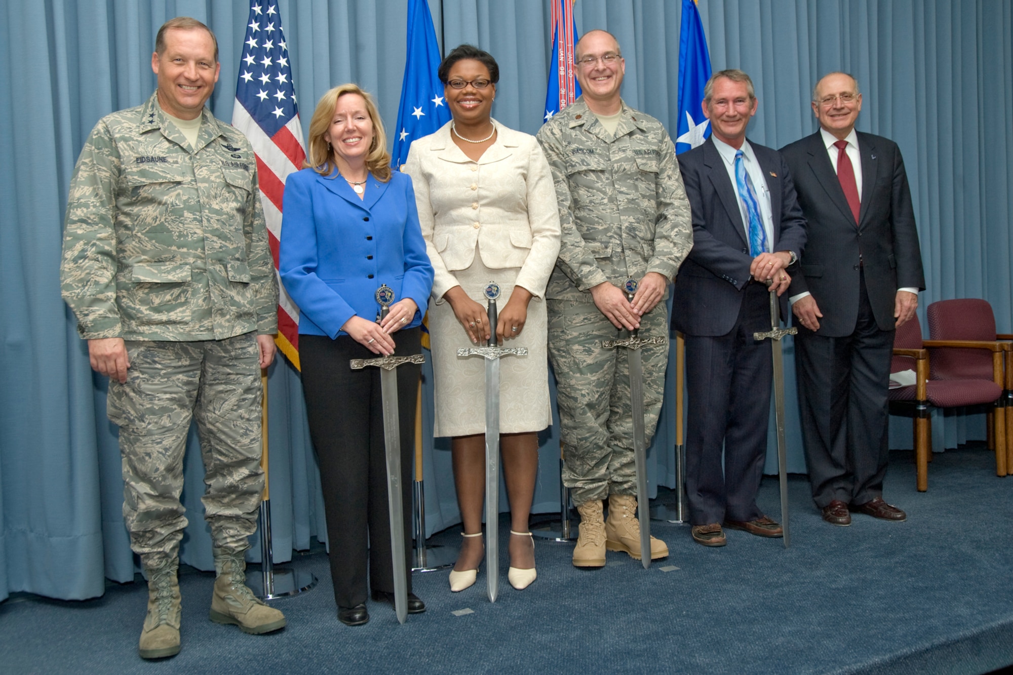 EGLIN AIR FORCE BASE, Fla. -- Maj. Gen. David Eidsaune, Air Armament Center commander, and Blaise Durante, Deputy Assistant Secretary for Acquisition Integration, Office of the Assistant Secretary of the Air Force for Acquisition (right), recognized Emily Jay, Maj. Phillip Bascom, Jill Barfield and Greg Hutto as as the Air Armament Academy Instructors of the Year, They were singled out for their contributions to professional education during an annual ceremony Feb. 5 where they received the Blaise Durante Instructor of the Year Award. (U.S. Air Force photo by Debbie Haussermann)