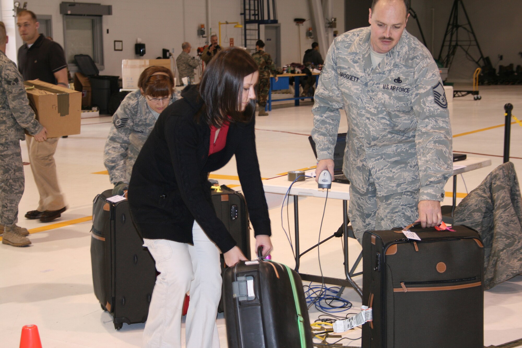 BOISE, Idaho – Senior Airman Teri Schneider, 366th Logistics Readiness Squadron, and Master Sgt. Scott Groggett, 266th Range Squadron, move luggage in a collection point within a C-130 hangar at Gowen Field, Idaho, Feb. 7. Several members of the 366th LRS, from Mountain Home Air Force Base volunteered their time to assist the Idaho Air National Guard with moving baggage for the 2009 Special Olympics World Winter Games. The Idaho National Guard stood up Joint Task Force – Special Olympics to perform a number of roles for the event. The 366th FW members’ time and efforts were critical in ensuring Special Olympics athletes from around the world had their baggage and equipment moved from Boise to event sites in McCall, Idaho, and Sun Valley, Idaho. (U.S. Army photo/ Lt. Col. Tim Marsano)
