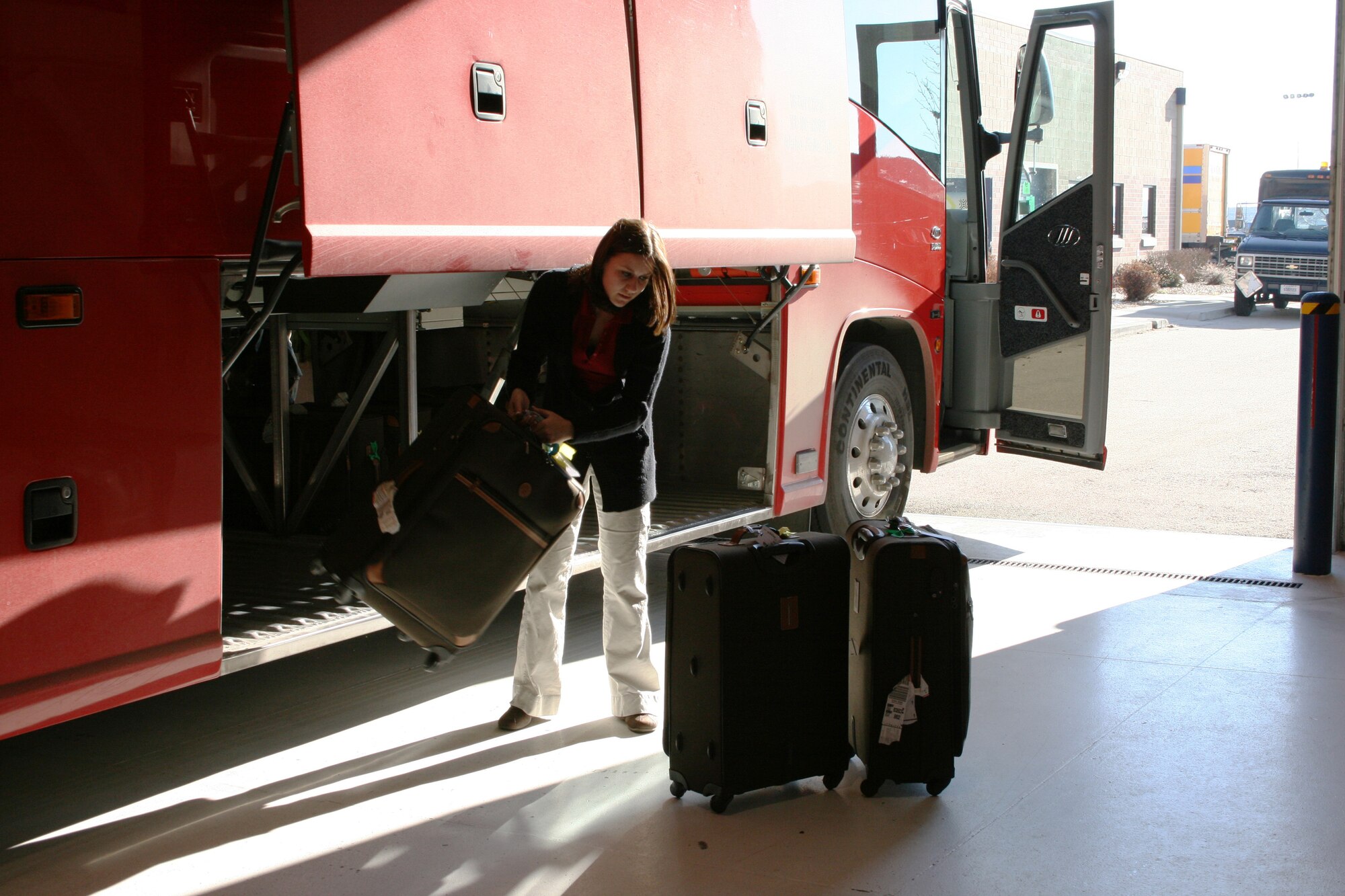 BOISE, Idaho – Senior Airman Teri Schneider, 366th Logistics Readiness Squadron, moves luggage from a bus to another collection point within a C-130 hangar at Gowen Field, Idaho, Feb. 7. Several members of the 366th LRS, from Mountain Home Air Force Base volunteered their time to assist the Idaho Air National Guard with moving baggage for the 2009 Special Olympics World Winter Games. The Idaho National Guard stood up Joint Task Force – Special Olympics to perform a number of roles for the event. The 366th FW members’ time and efforts were critical in ensuring Special Olympics athletes from around the world had their baggage and equipment moved from Boise to event sites in McCall, Idaho, and Sun Valley, Idaho. (U.S. Army photo/ Lt. Col. Tim Marsano)