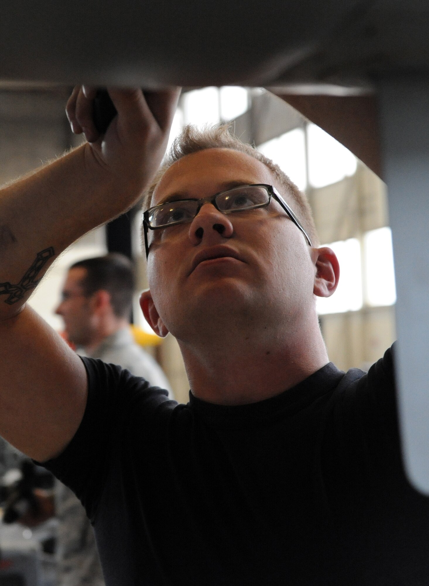 MOUNTAIN HOME AIR FORCE BASE, Idaho -- Senior Airman A.J. Faber, 390th Aircraft Maintenance Unit weapons load technician, loosens a bolt to look under a panel at the base's weapons load crew of the year competition Feb. 5. The 390th AMU finished with a time of 34:38 and the 391st AMU crew finished with a time of 50:17. The winners will be announced during the 366th Operations Group banquet in April. (U.S. Air Force photo/ Airman 1st Class Debbie Lockhart)