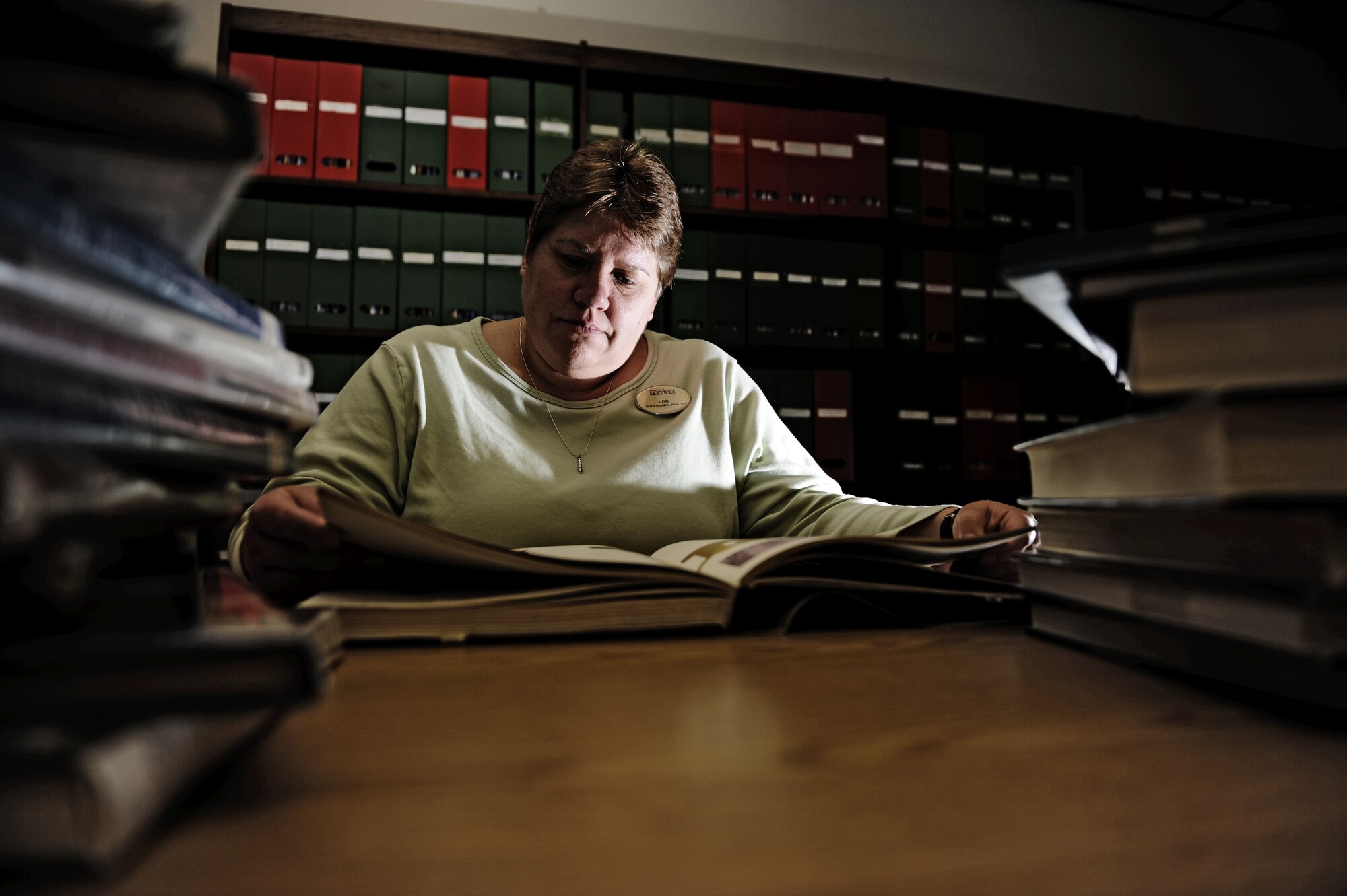 MOUNTAIN HOME AIR FORCE BASE, Idaho -- Lori, 366th Services Squadron library children’s coordinator, reads through one of the many books in the library Jan 29. The base library offers numerous services to military members and their families in the form of books, movies, internet access and children’s story time. (U.S. Air Force photo/ Senior Airman Ryan Crane)