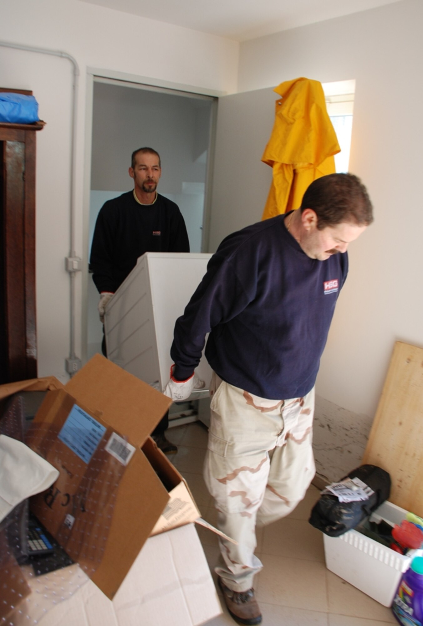 Italian employees from Camp Darby's Central Furnishing Management Office haul away a washing machine Feb. 9 damaged during the Feb. 6 flood which hit Pisa, Livorno and Camp Darby, Italy areas.  (U.S. Army photo by Joyce Costello.)