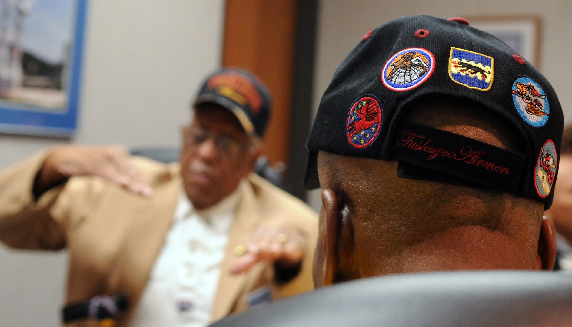 Thomas Ellis, a Tuskegee Airman administrative clerk with the 301st Fighter Squadron, speaks with other Tuskegee Airmen during the First Tuskegee Heritage Breakfast on Feb. 9 at the 99th Flying Training Squadron. Activated on March 22, 1941, the 99th FTS was originally designated as the 99th Pursuit Squadron, and was better known as the "Tuskegee Airmen," the first all-black unit in the U.S. Army Air Corps. (U.S. Air Force photo by Rich McFadden)
