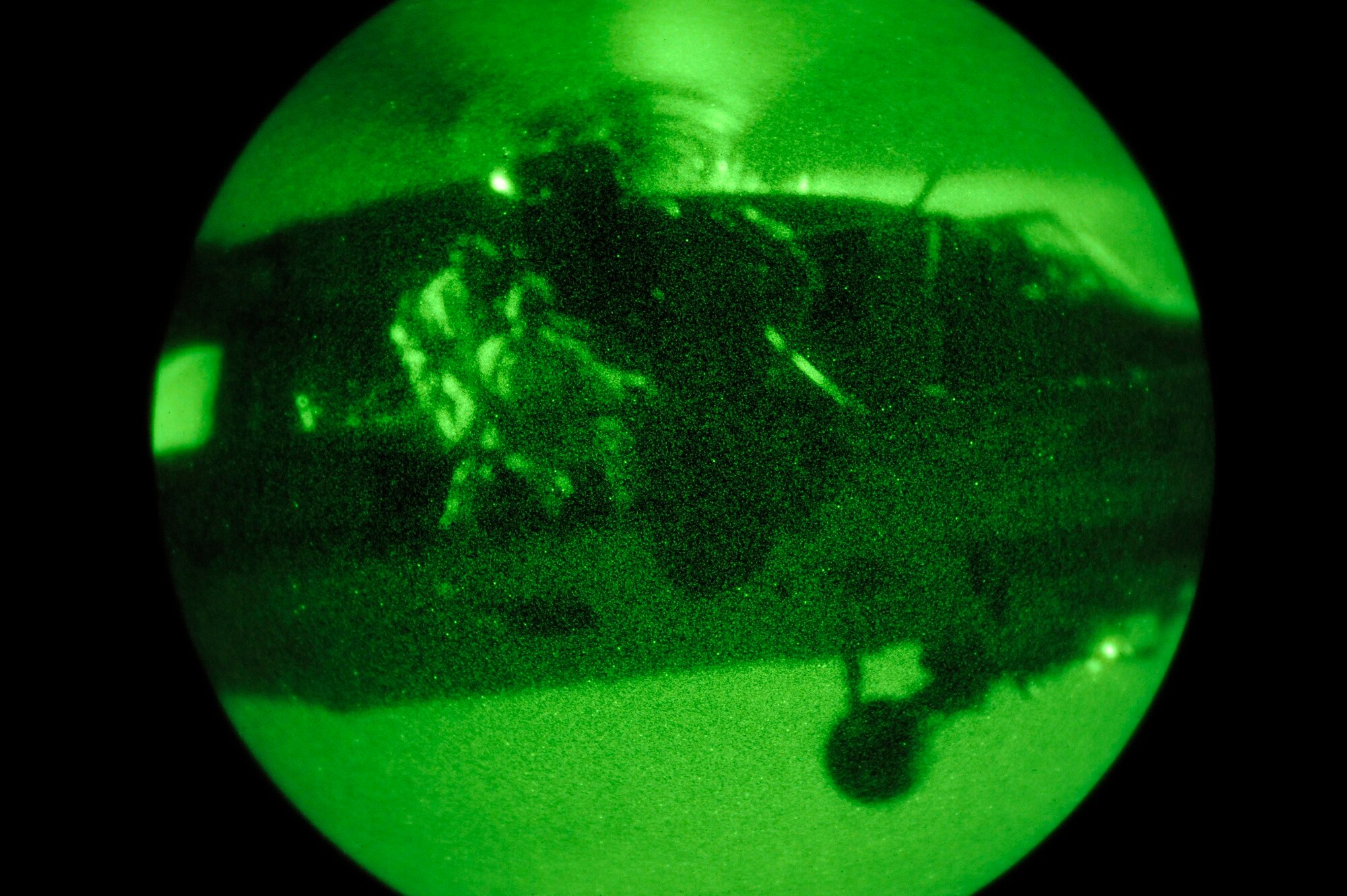 Two military members deploy from an HH-60 Pave Low helicopter Feb 9 during an Emerald Warrior Exercise training scenario. Air Force Special Operations Command officials are hosting Emerald Warrior to train forces in combat scenarios.  The exercise runs until Feb. 13. (U.S. Air Force photo/Staff Sgt. Desiree N. Palacios)