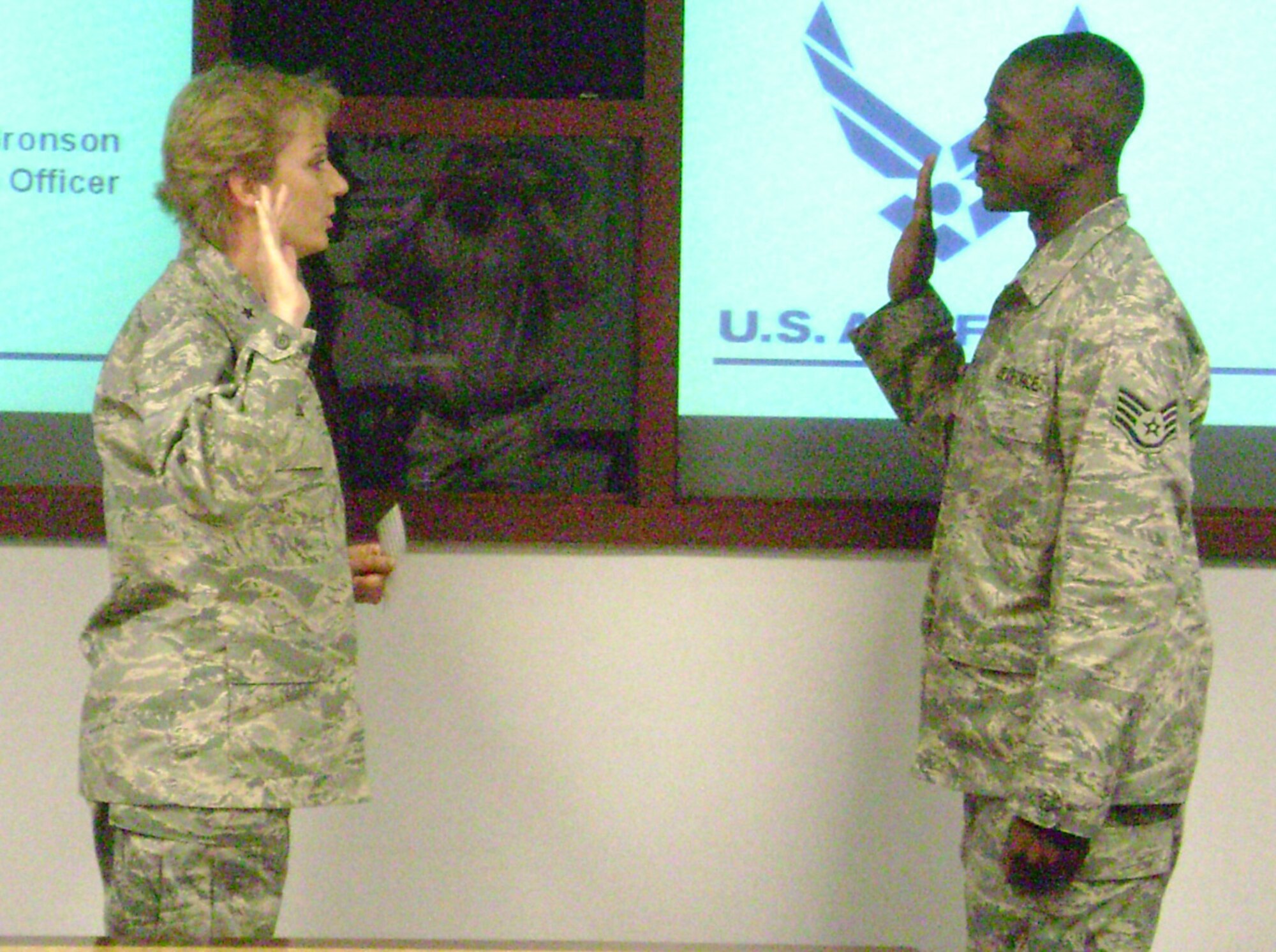 SEYMOUR JOHNSON AIR FORCE BASE, N.C. -- Staff Sgt. William Opoku, a Reservist with the 916th Communication Squadron, re-enlists as Brig. Gen. Wendy Masiello presents the oath. Currently Sgt. Opoku is on duty at the Pentagon.