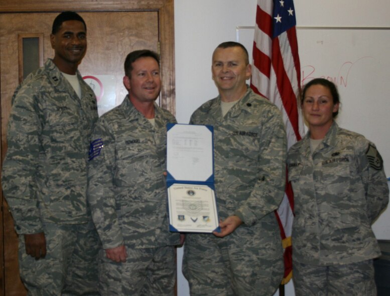 SEYMOUR JOHNSON AIR FORCE BASE, N.C. -- Tech. Sgt. Kevin Howard (center left) receives his promotion certificate and rank from Lt. Col. James Horton (center right). Sgt. Howard is a Reservist with the 916th Communication Squadron and works as an electrical components and switching technician.  Standing with Sgt. Howard are Capt. Terrance Spikes (left) and Master Sgt. Jennifer Conway (right).