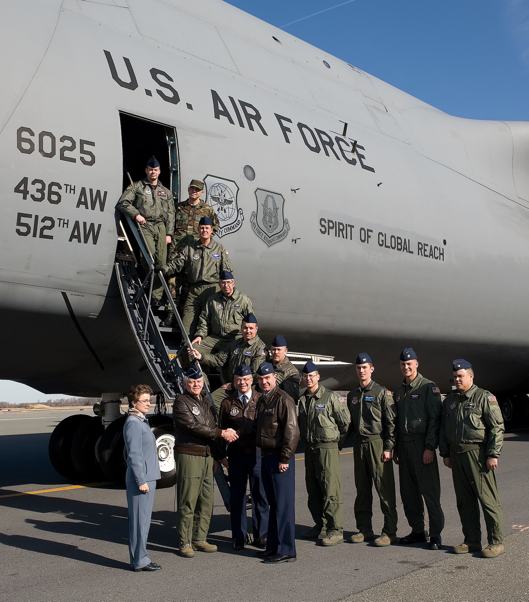 The Spirit of Global Reach, Team Dover's first C-5M Super Galaxy, was delivered Feb. 9.  (Front, from right) Col. Manson Morris, 436th Airlift Wing commander, and Col. Randal Bright, 512th AW commander, greet Gen. Arthur Lichte, Air Mobility Command commander and the delivery official for the C-5M, and Lorraine Martin, Lockheed Martin C-5 program vice president, while the delivery crew poses in the background.  (U.S. Air Force photo/Jason Minto)