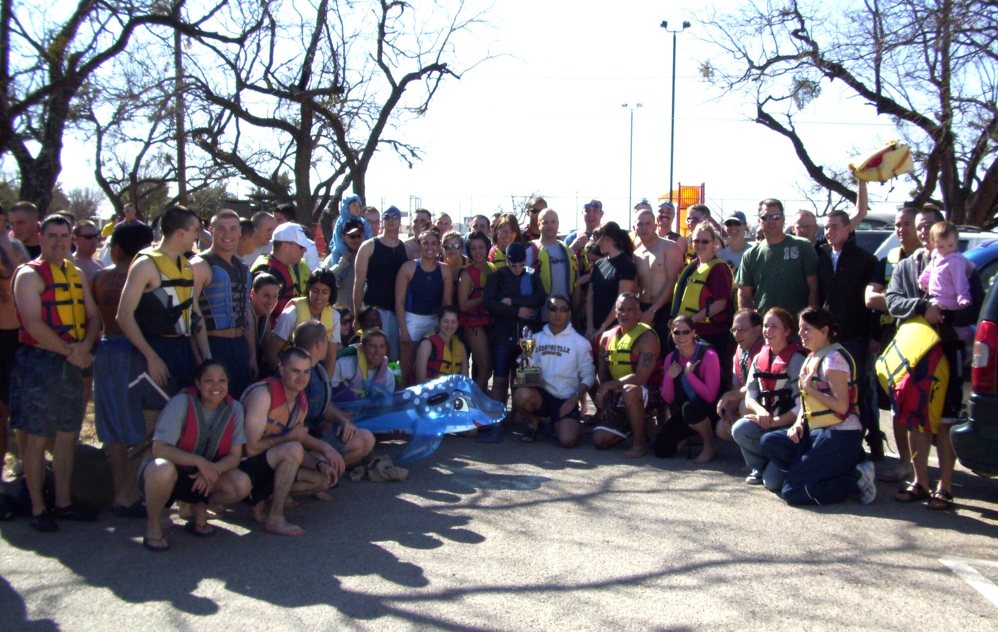Lieutenant Colonel Thomas Dobbs, 316th Training Squadron commander, and Chief Master Sgt. Bob Benitez, 316 TRS superintendent, pose with squadron members following the Polar Bear Swim at Lake Nasworthy on Jan. 31.  The 316 TRS maintained its tight grip on the Polar Bear trophy, winning the award for having the largest number of squadron members take the icy plunge into near-freezing waters.  The 316 TRS has won the Polar Bear trophy three years in a row and six times in seven years.  The front page caption from last week's Monitor mistakenly stated that the 315th Training Squadron won this year's trophy.
