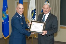 HANSCOM AIR FORCE BASE, Mass. – Col. Jackson Dobbins (left), 66th Medical Group commander, presents a certificate to Dr. David Barrett, president and chief executive officer of Lahey Clinic in Burlington, Mass., following his induction as the 66th Medical Group Honorary Commander during a ceremony on Feb. 6, at the Hanscom Conference Center. The Honorary Commander program is designed to educate participants as well as build and improve relationships with local civic and community leaders by providing greater access to Air Force commanders, programs, personnel and operations. (U.S. Air Force photo by Rick Berry) 