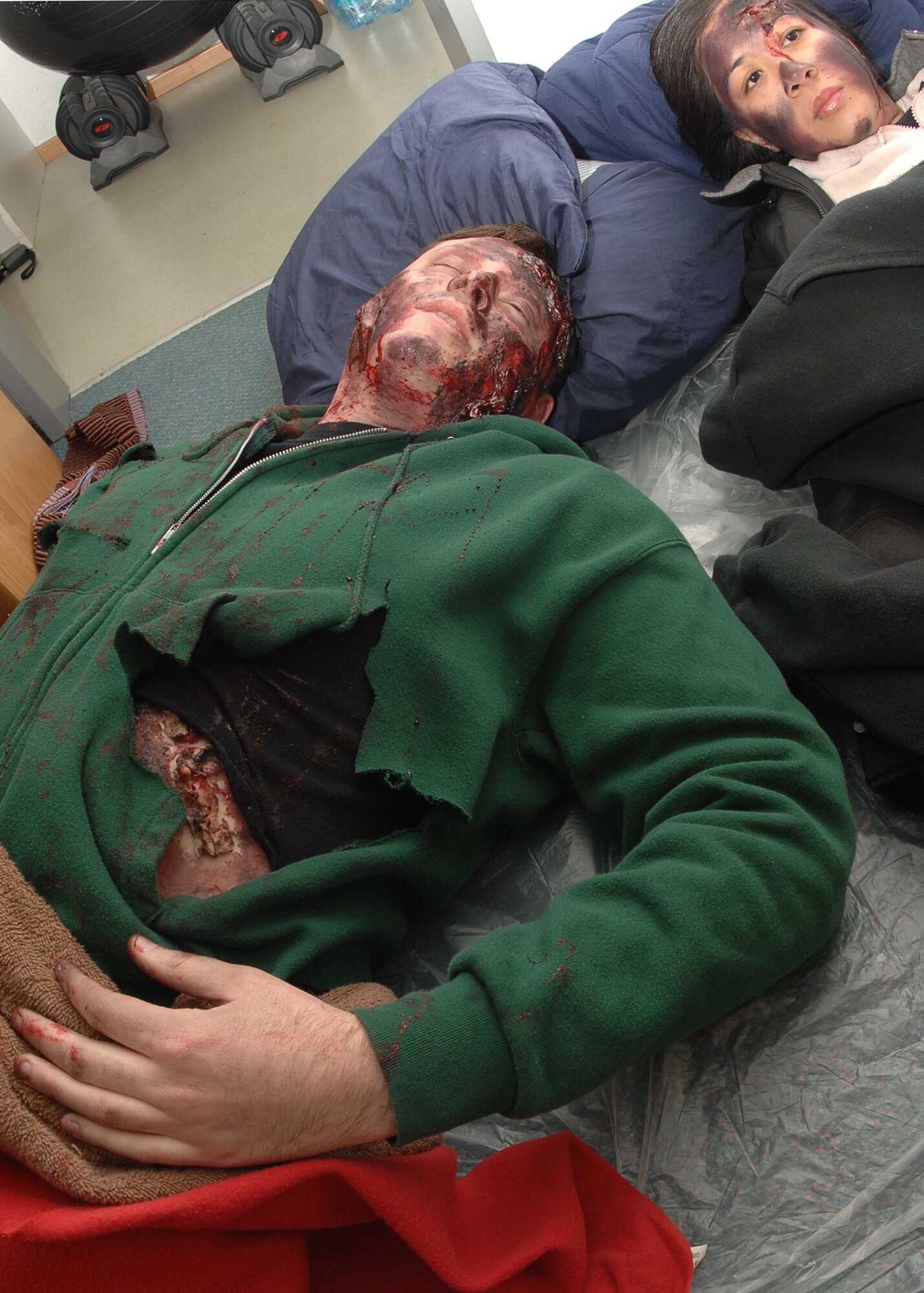 SPANGDAHLEM AIR BASE, Germany -- Staff Sgt. Matt Van Sise and Airman 1st Class Sheryll Houston, 52nd Equipment Maintenance Squadron, are simulated casualties during an exercise Jan. 29, 2009.  The Emergency Management Major Accident War Trophy Munition exercise trains military personnel for real-life situations by testing the base’s response skills and capabilities. (U.S. Air Force photo by Airman 1st Class Nicholas Wilson)