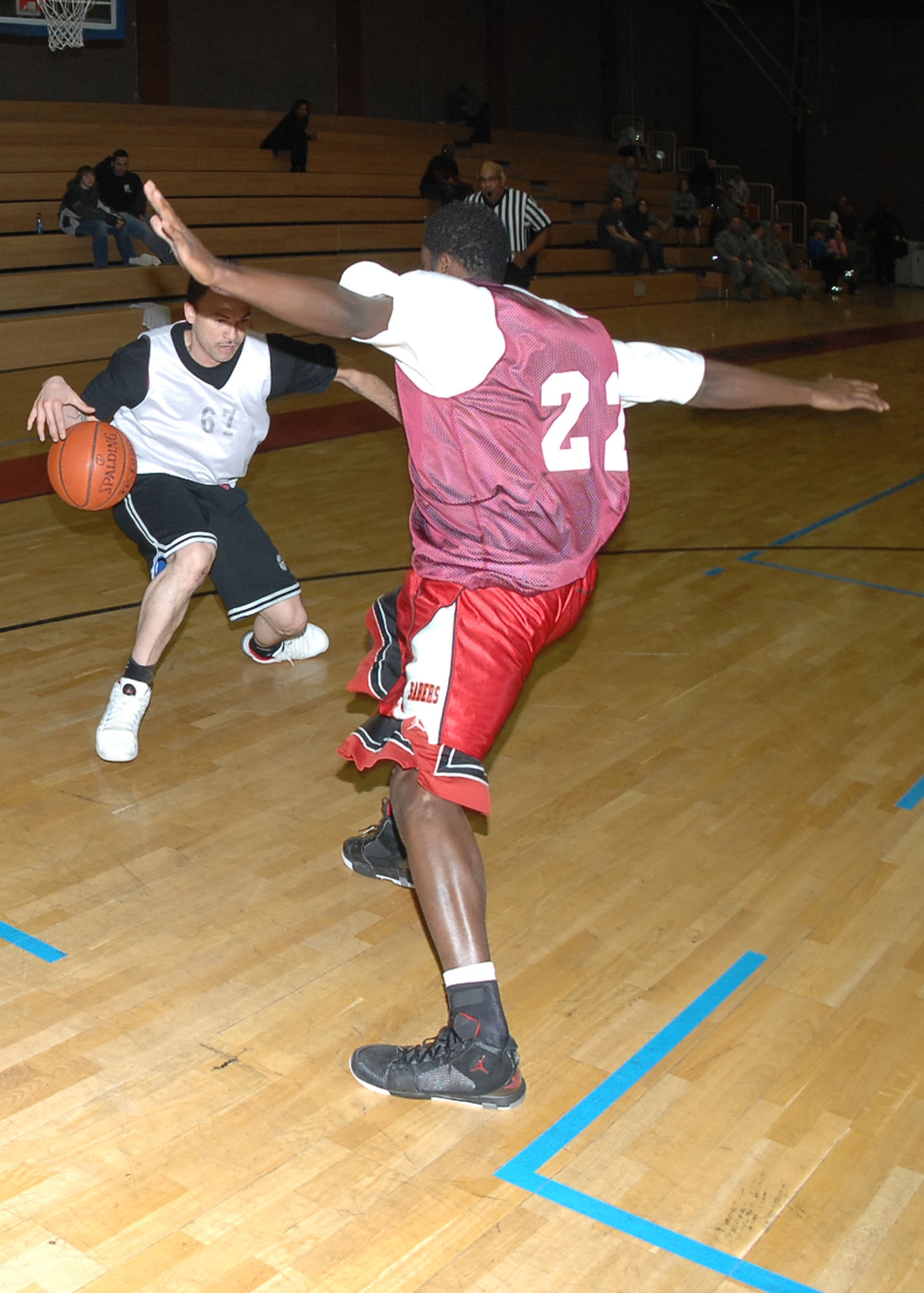 SPANGDAHLEM AIR BASE, Germany -- Staff Sgt. Marcus Freeman, 52nd Communications Squadron, evades a Security Forces Squadron defender during an intramural playoff game Jan. 29, 2009. The 52nd CS defeated the 52nd SFS with a score of 53-44 to advance in the tournament. (U.S. Air force photo by Airman 1st Class Nicholas Wilson)
