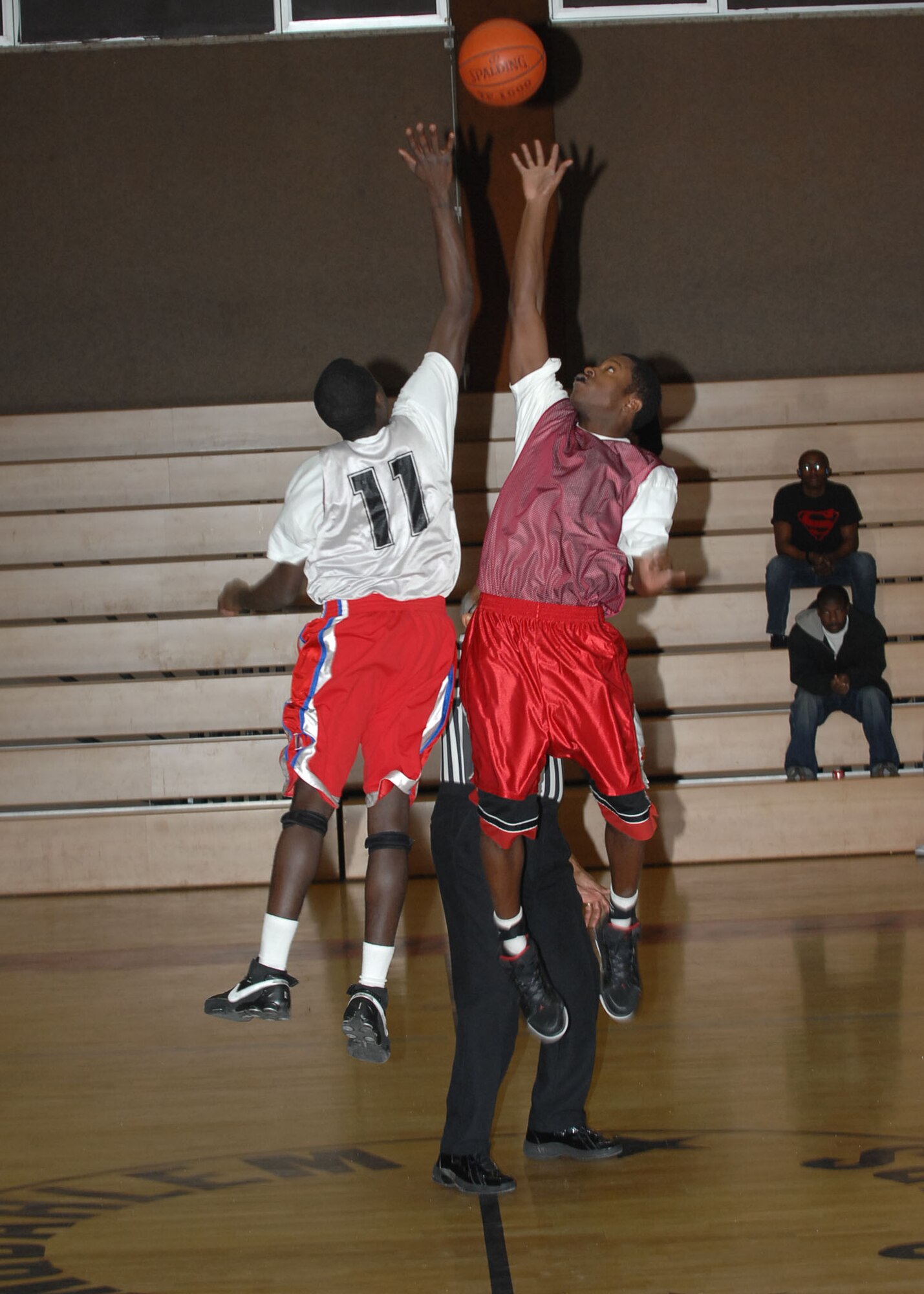 SPANGDAHLEM AIR BASE, Germany -- Senior Airman Tyrone Bullocks, 52nd Security Forces Squadron, goes up against Airman 1st Class Artis Gandy, 52nd Communications Squadron, for the ball during the tip-off of an intramural playoff game Jan. 29, 2009. The 52nd CS defeated the 52nd SFS with a score of 53-44 to advance in the tournament. (U.S. Air Force photo by Airman 1st Class Nicholas Wilson)