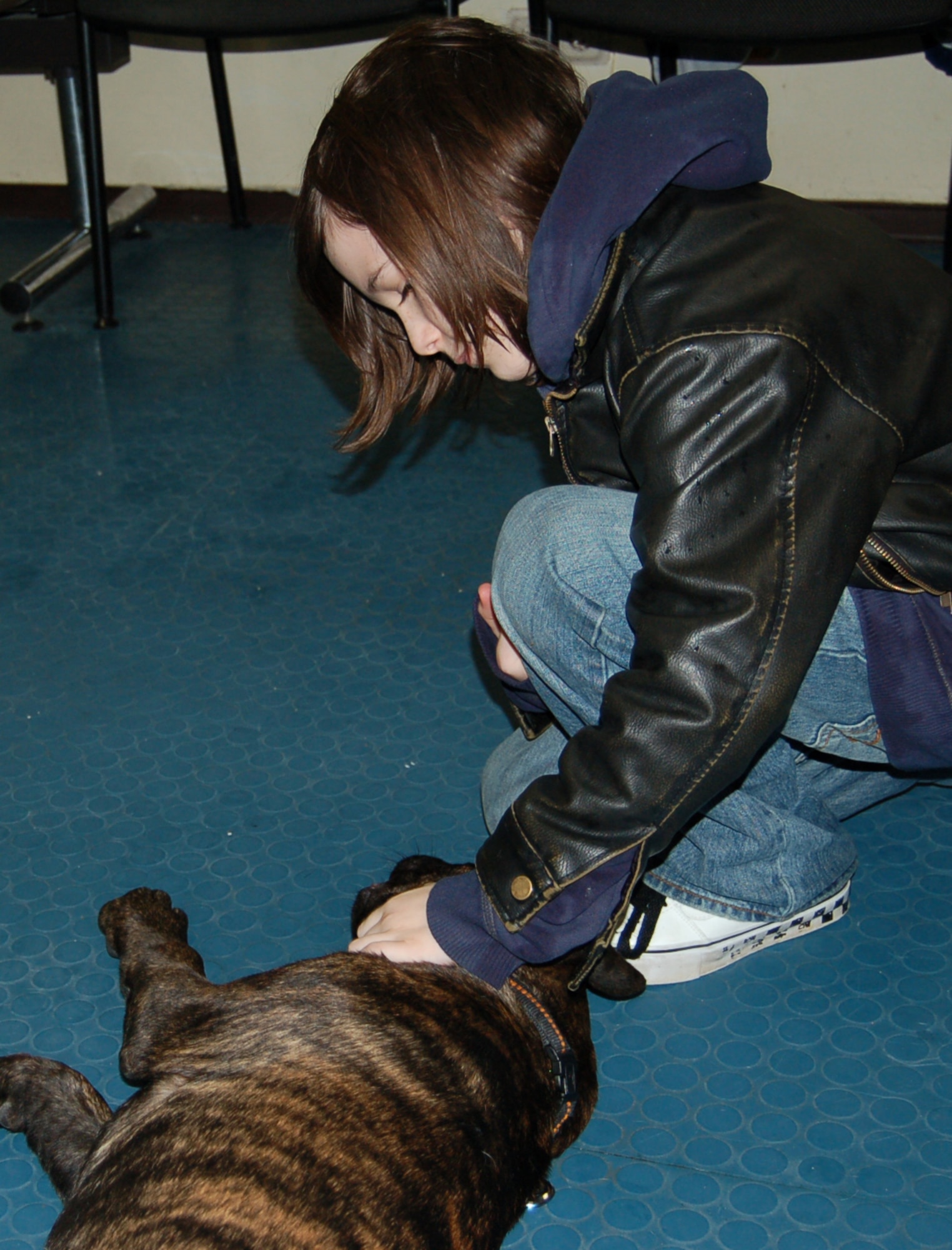 SPANGDAHLEM AIR BASE, Germany – Trevor Dolduc, son of Staff Sgt. Christina Johnson, 52nd Medical Operations Squadron, pets his dog Mojo after he properly followed a command for him. Mojo is enrolled in the Pet Spa’s Puppy Kindergarten class. The class is designed to teach puppies basic obedience commands like “sit,” “stay” and “lay down.” (U.S. Air Force photo by Staff Sgt. Tammie Moore)