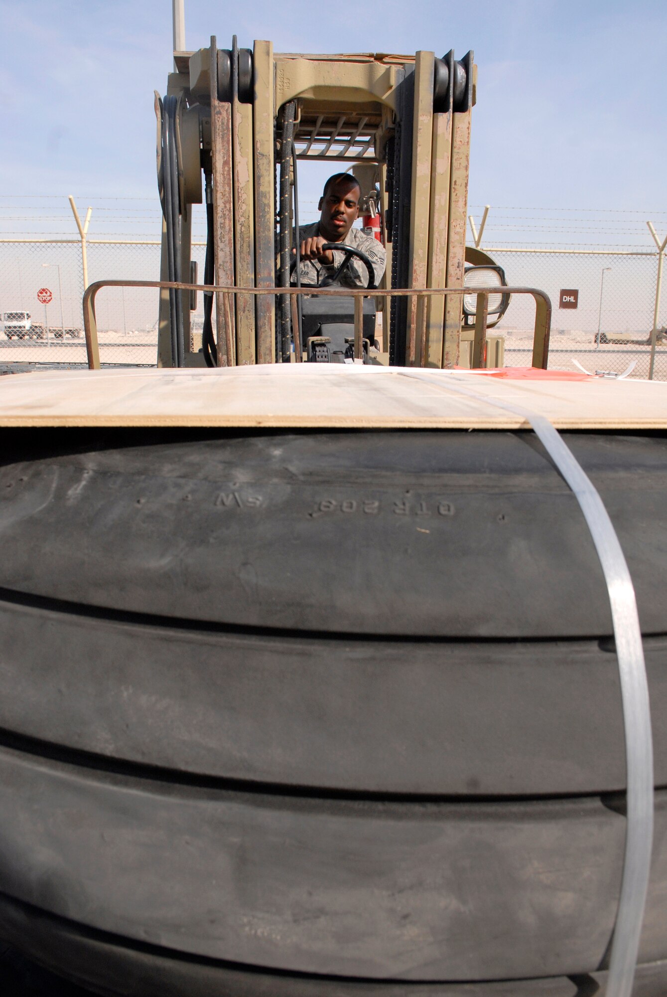 Senior Airman Michael Vanlear, a 379th ELRS Traffic Management Apprentice, stacks new tires for a C-130 aircraft, for delivery to the flightline, Feb. 10, 2009, at an undisclosed location in Southwest Asia.  Senior Airman Vanlear hails from Oklahoma City, Okla. and is deployed from Charleston AFB, S.C. in support of Operation Iraqi and Enduring Freedom and Combined Joint Task Force- Horn of Africa.  (U.S. Air Force photo/Airman 1st Class Andrew Satran/released) 