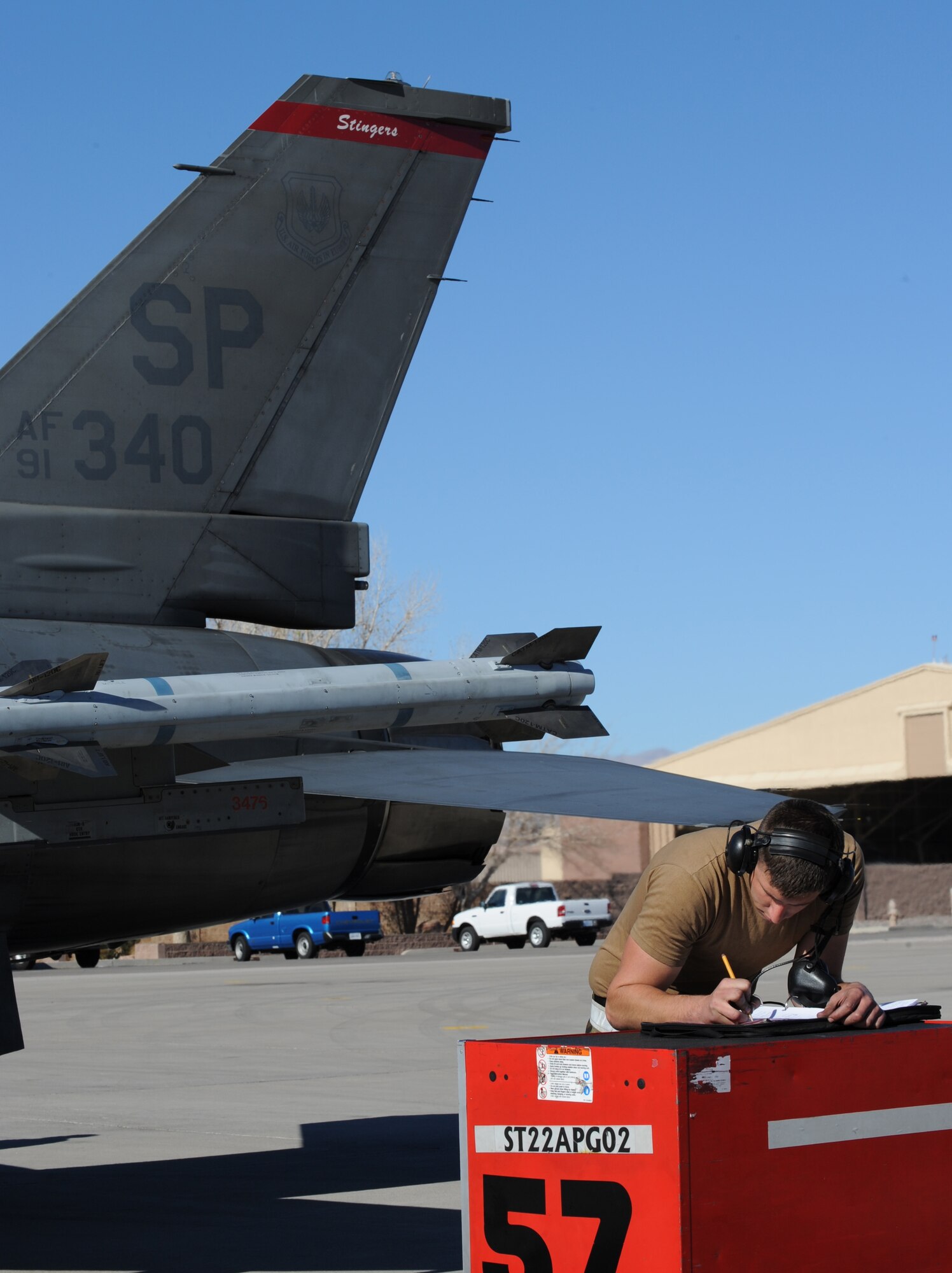NELLIS AIR FORCE BASE, Nev. -- Airman 1st Class Dennis Little, 52nd Aircraft Maintenance Squadron, Spangdahlem, Air Base, Germany, makes final annotations for maintenance on an F-16CJ Fighting Falcon while in support of the U.S. Air Force Weapons School, Nellis Air Force Base, Nev., Jan. 29, 2009. The USAF Weapons School is responsible for teaching graduate-level instructor courses that provide the world's most advanced training in weapons and tactics employment to officers of the combat air forces. (U.S. Air Force photo/Senior Airman Nadine Y. Barclay) 
