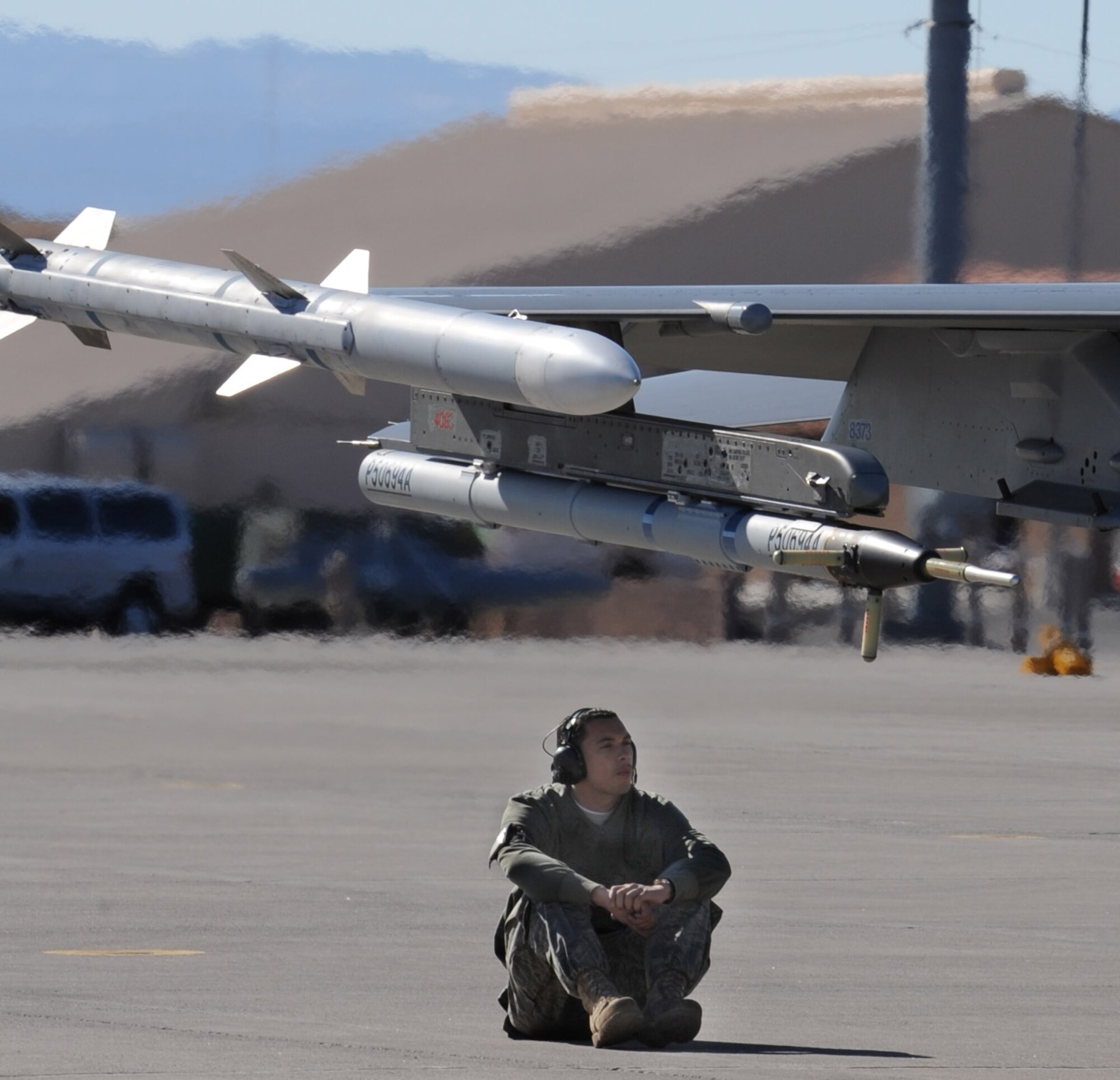 NELLIS AIR FORCE BASE, Nev. -- Airman 1st Class Hector Andrew, 52nd Aircraft Maintenance Squadron, Spangdahlem Air Base, Gemany, patiently awaits the pilot of an F-16CJ Fighting Falcon to complete all pre-flight checks during a routine exercise while in support of the U.S. Air Force Weapons School, Nellis Air Force Base, Nev., Jan. 29, 2009. The USAF Weapons School is responsible for teaching graduate-level instructor courses that provide the world's most advanced training in weapons and tactics employment to officers of the combat air forces. (U.S. Air Force photo/Senior Airman Nadine Y. Barclay) 
