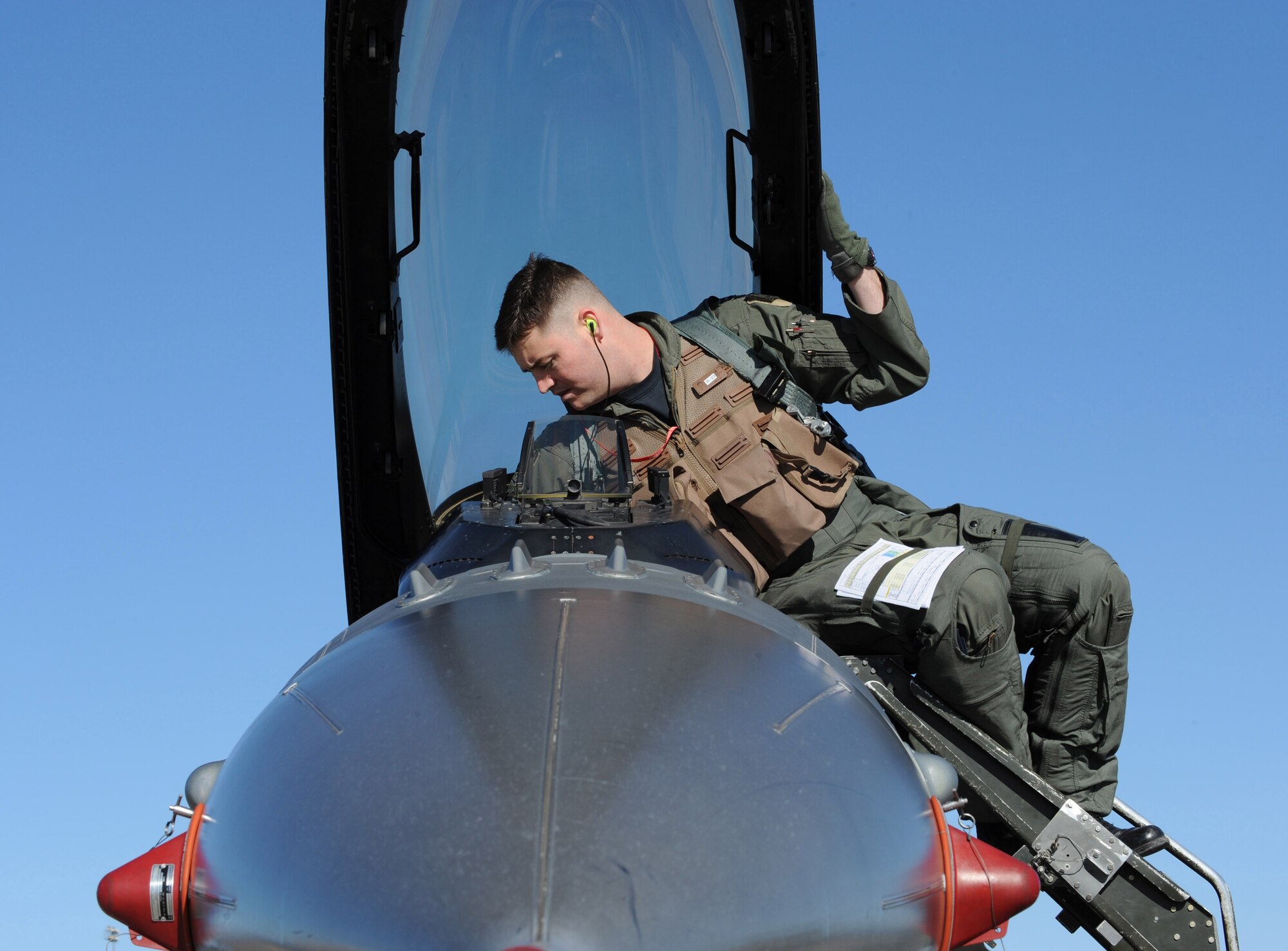 NELLIS AIR FORCE BASE, Nev. -- Captain Joseph White, 22nd Fighter Squadron, Spangdahlem Air Base, Gemany, makes final preparations for a flight in a F-16CJ while in support of the U.S. Air Force Weapons School, Nellis Air Force Base, Nev., Jan. 29, 2009. The USAF Weapons School is responsible for teaching graduate-level instructor courses that provide the world's most advanced training in weapons and tactics employment to officers of the combat air forces. (U.S. Air Force photo/Senior Airman Nadine Y. Barclay)
