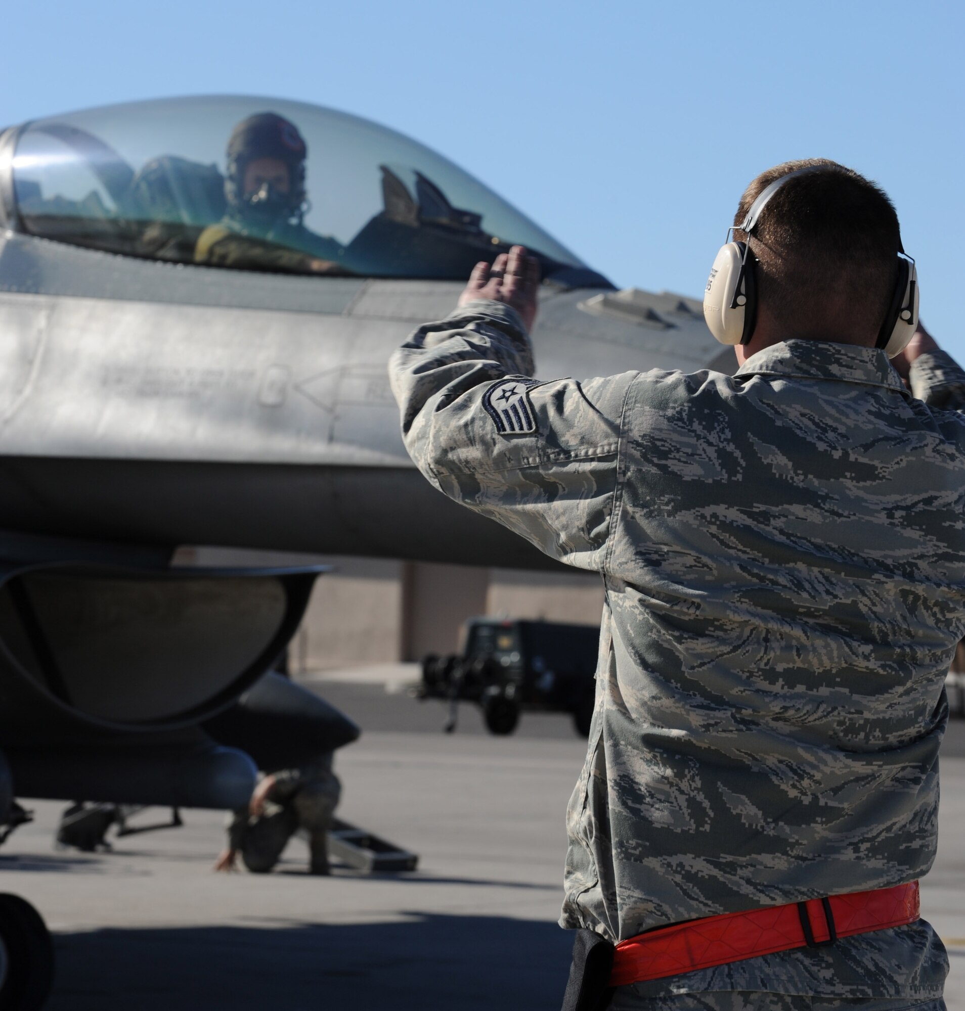 NELLIS AIR FORCE BASE, Nev. -- Staff Sgt Justin Ashworth, 52nd Aircraft Maintenance Squadron, Spangdahlem Air Base, Gemany, taxis out the pilot of an F-16CJ Fighting Falcon while in support of the U.S. Air Force Weapons School, Nellis Air Force Base, Nev., Jan. 29, 2009. The USAF Weapons School is responsible for teaching graduate-level instructor courses that provide the world's most advanced training in weapons and tactics employment to officers of the combat air forces. (U.S. Air Force photo/Senior Airman Nadine Y. Barclay) 
